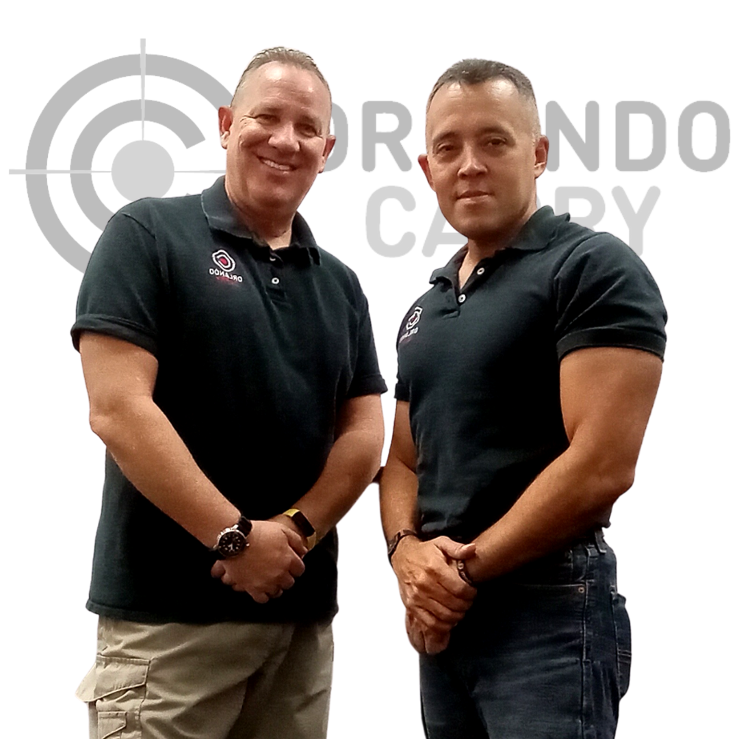 Certified NRA Instructors & Range Safety Officers Craig Schield and Luis Feliciano with Orlando Carry logo in background