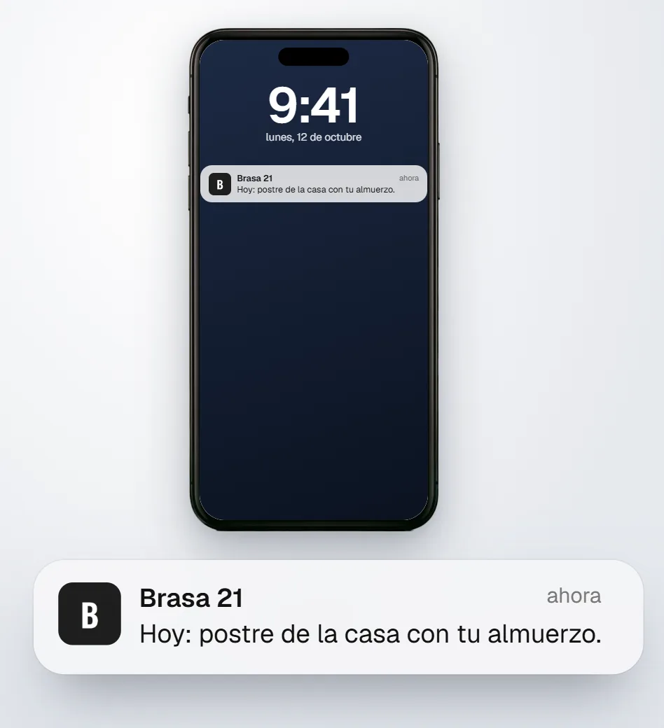 Un iPhone con el aviso de Brasa 21 en la pantalla de bloqueo: hoy, postre de la casa con tu almuerzo.