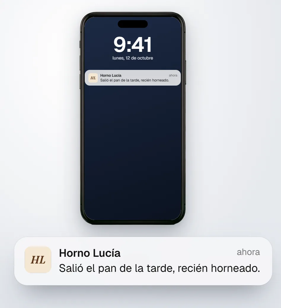 Un iPhone con el aviso de Horno Lucía en la pantalla de bloqueo: salió el pan de la tarde, recién horneado.