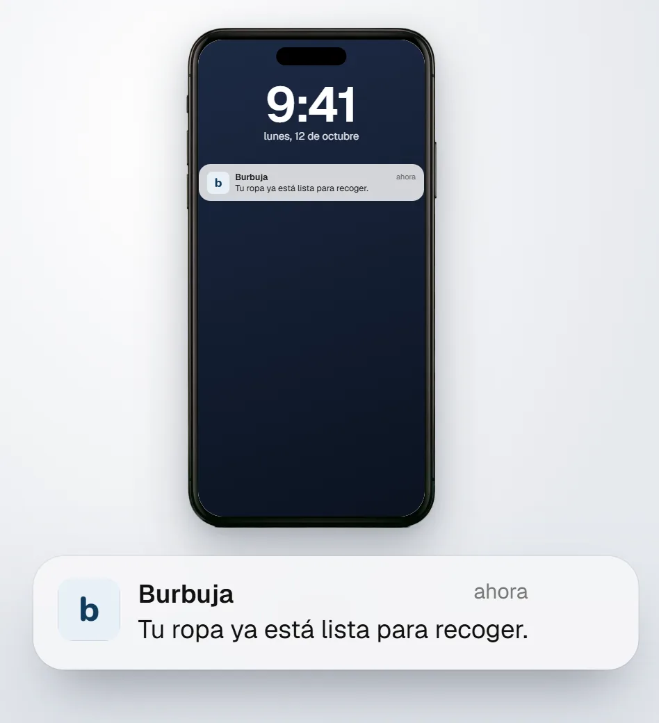 Un iPhone con el aviso de Burbuja en la pantalla de bloqueo: tu ropa ya está lista para recoger.