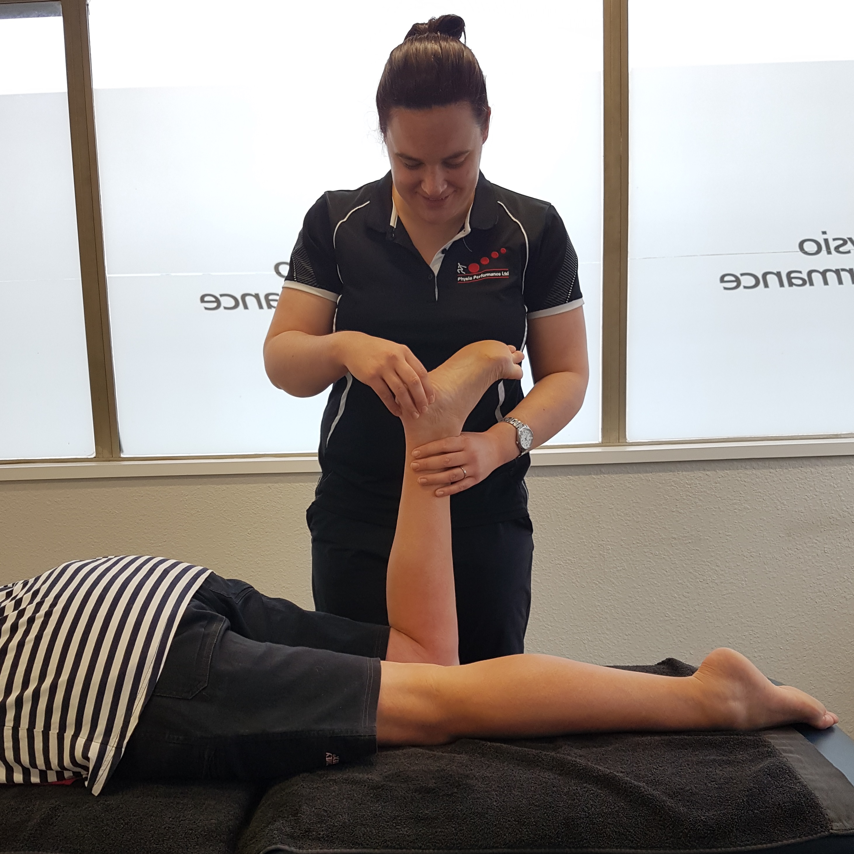 Physiotherapist assessing client during first appointment in Dunedin