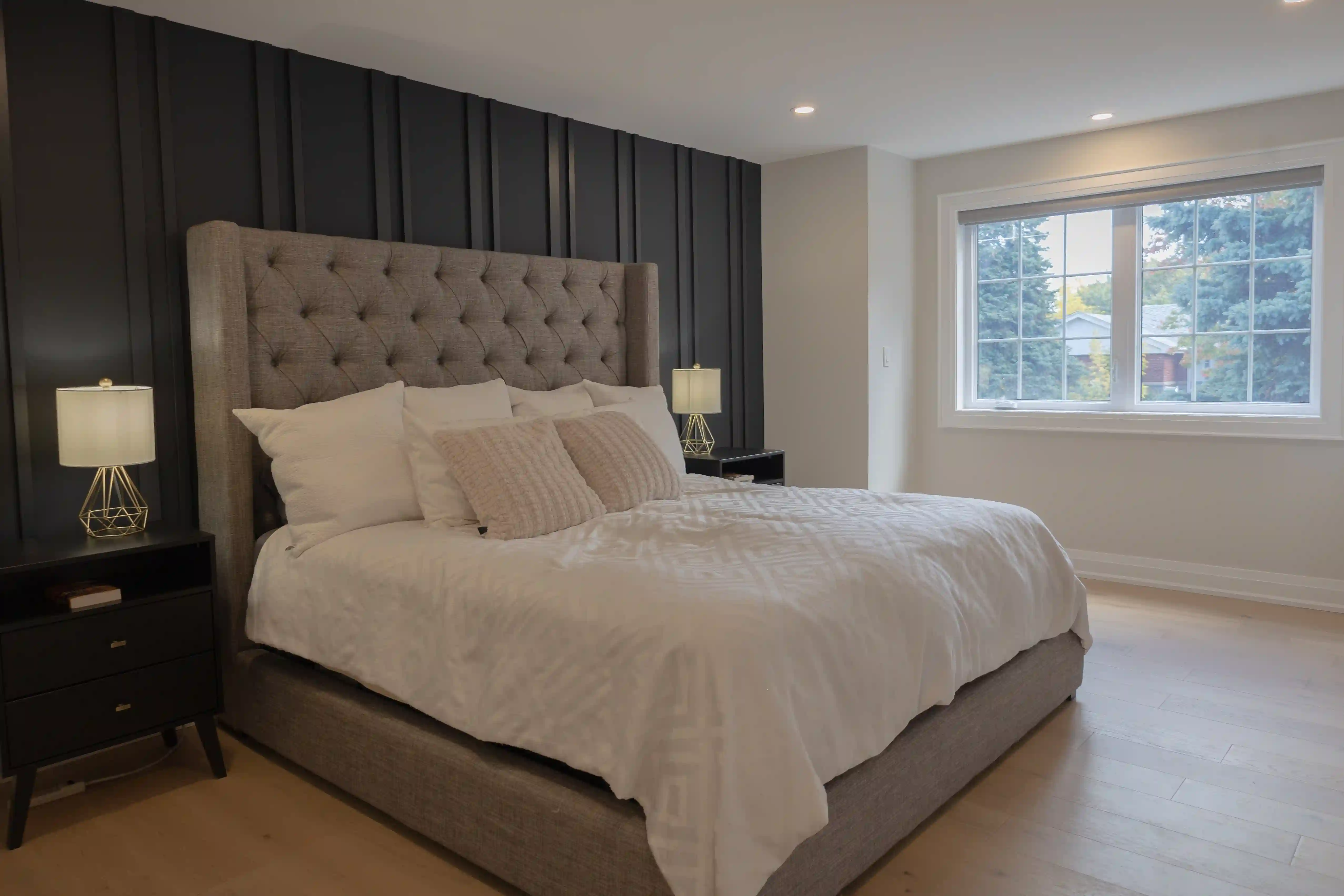 Primary bedroom with paneled feature wall