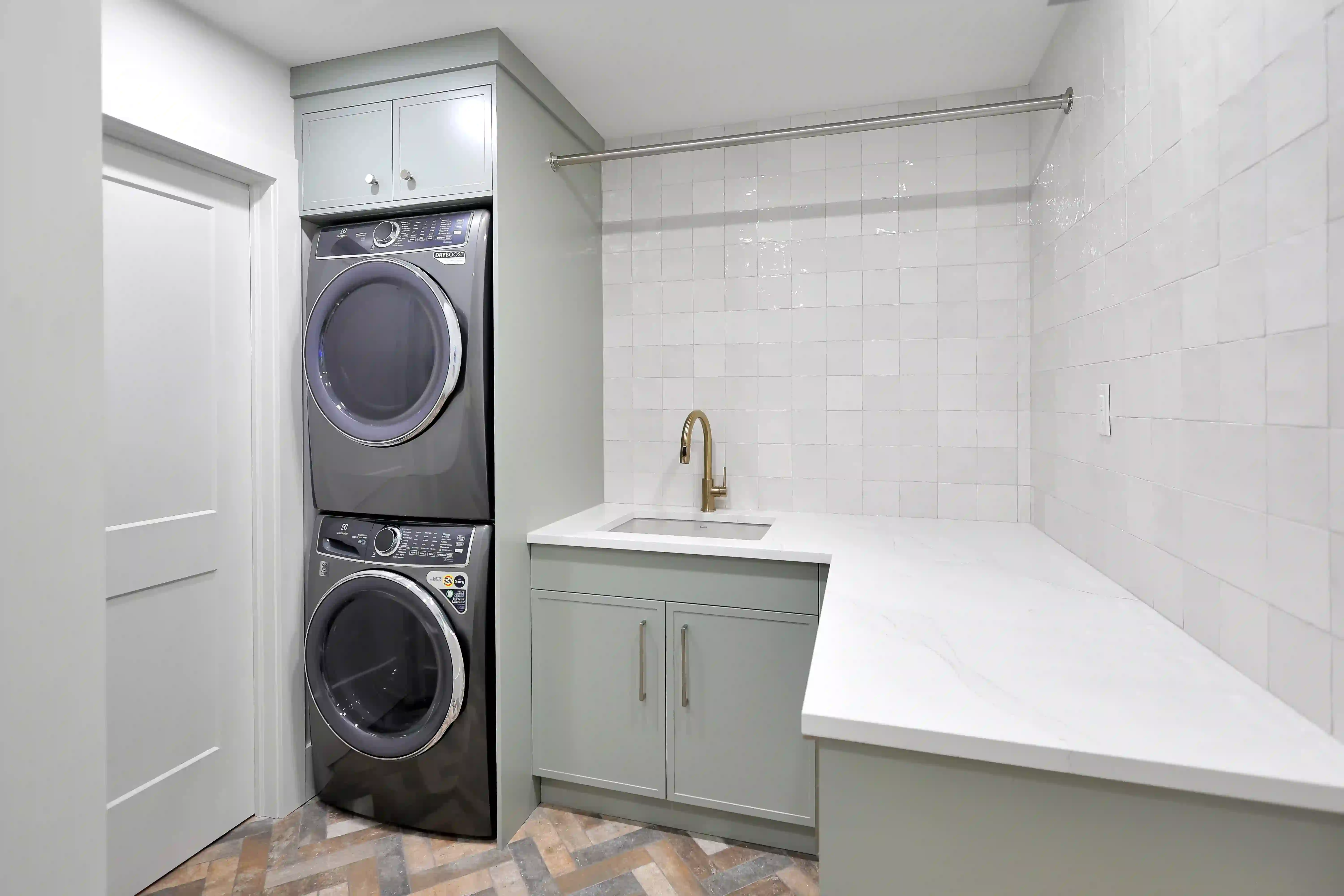 Laundry room with stacked washer and dryer