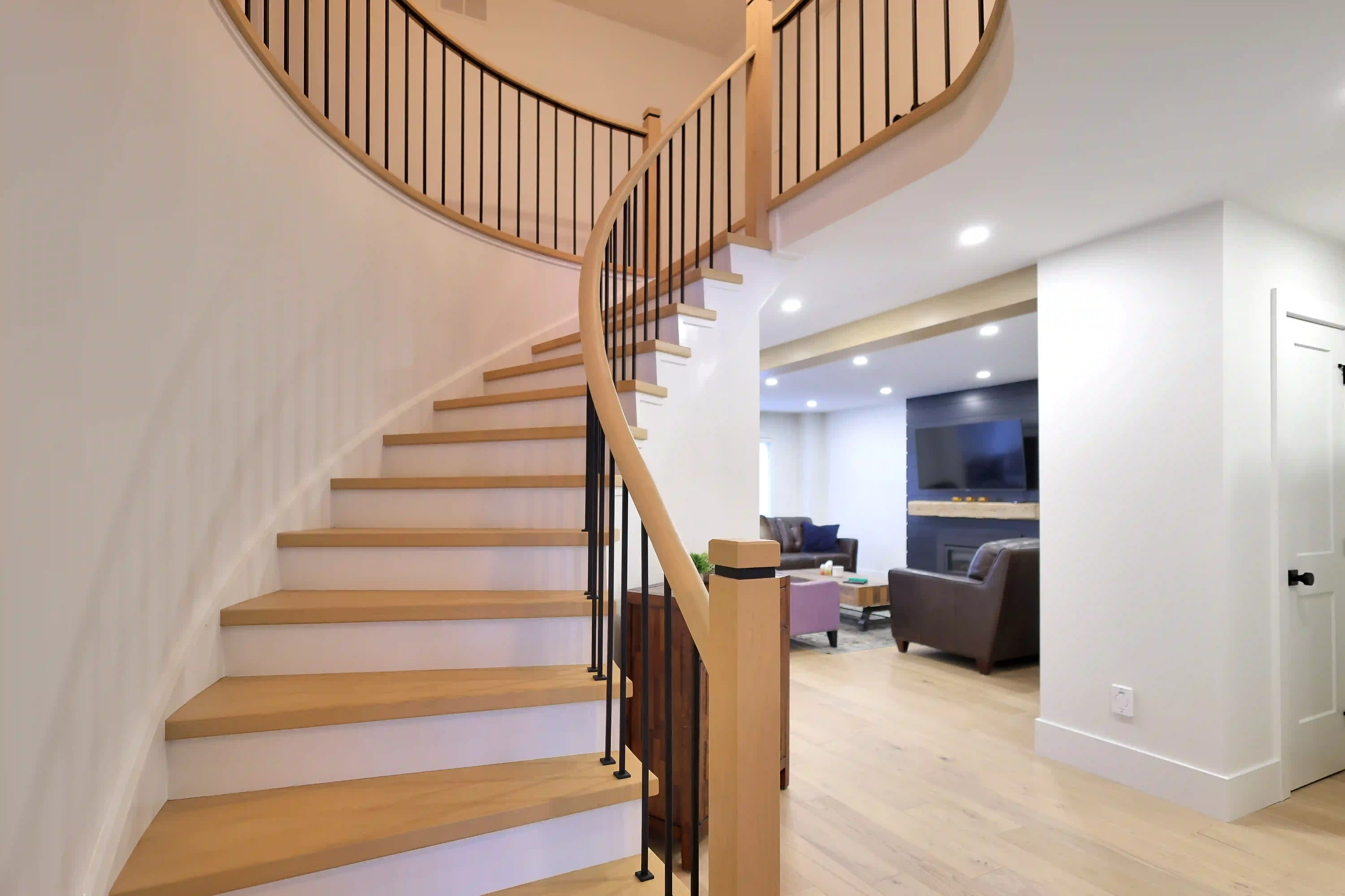 Curved staircase and living room connection