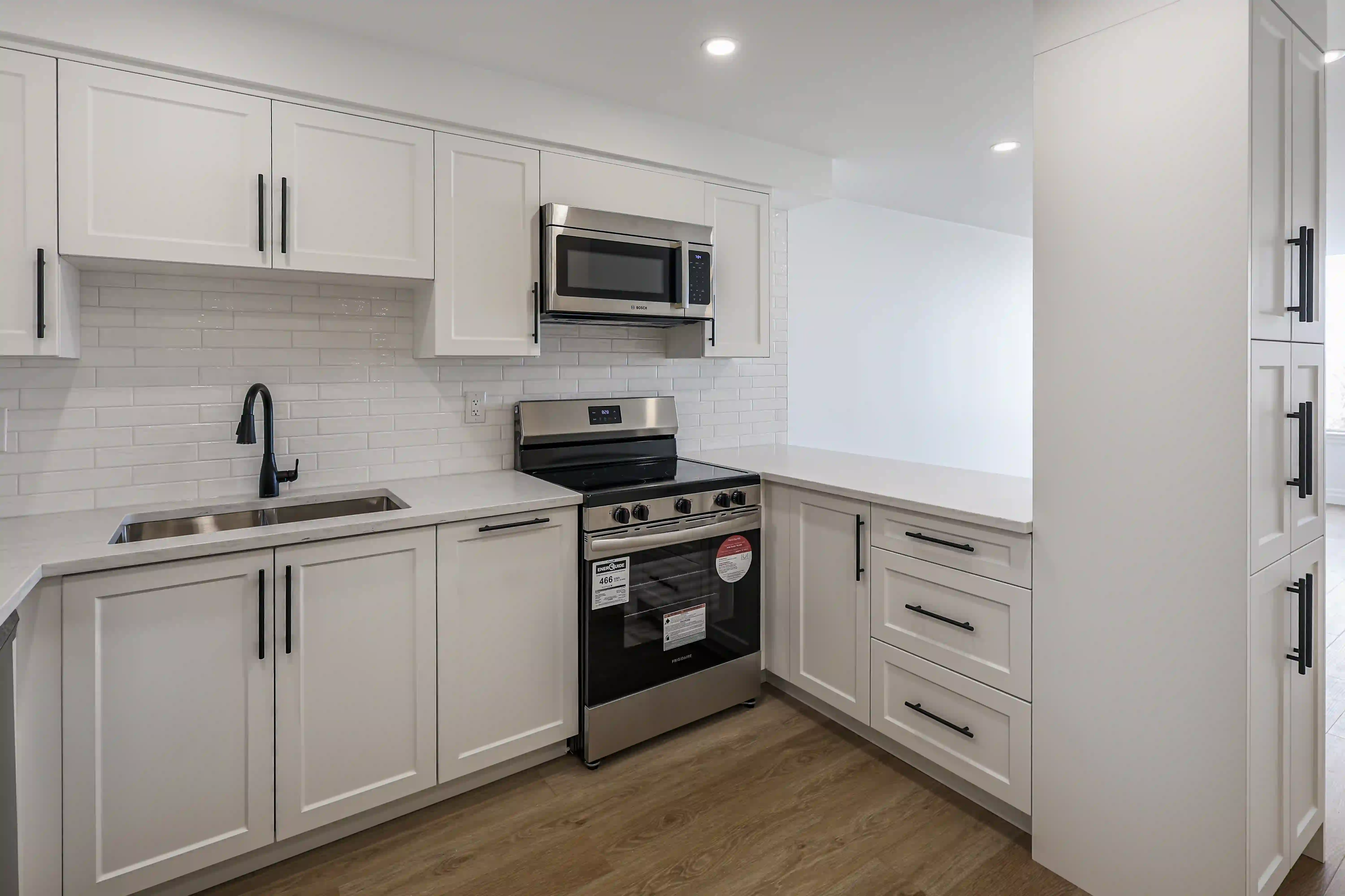 Compact white kitchen with range