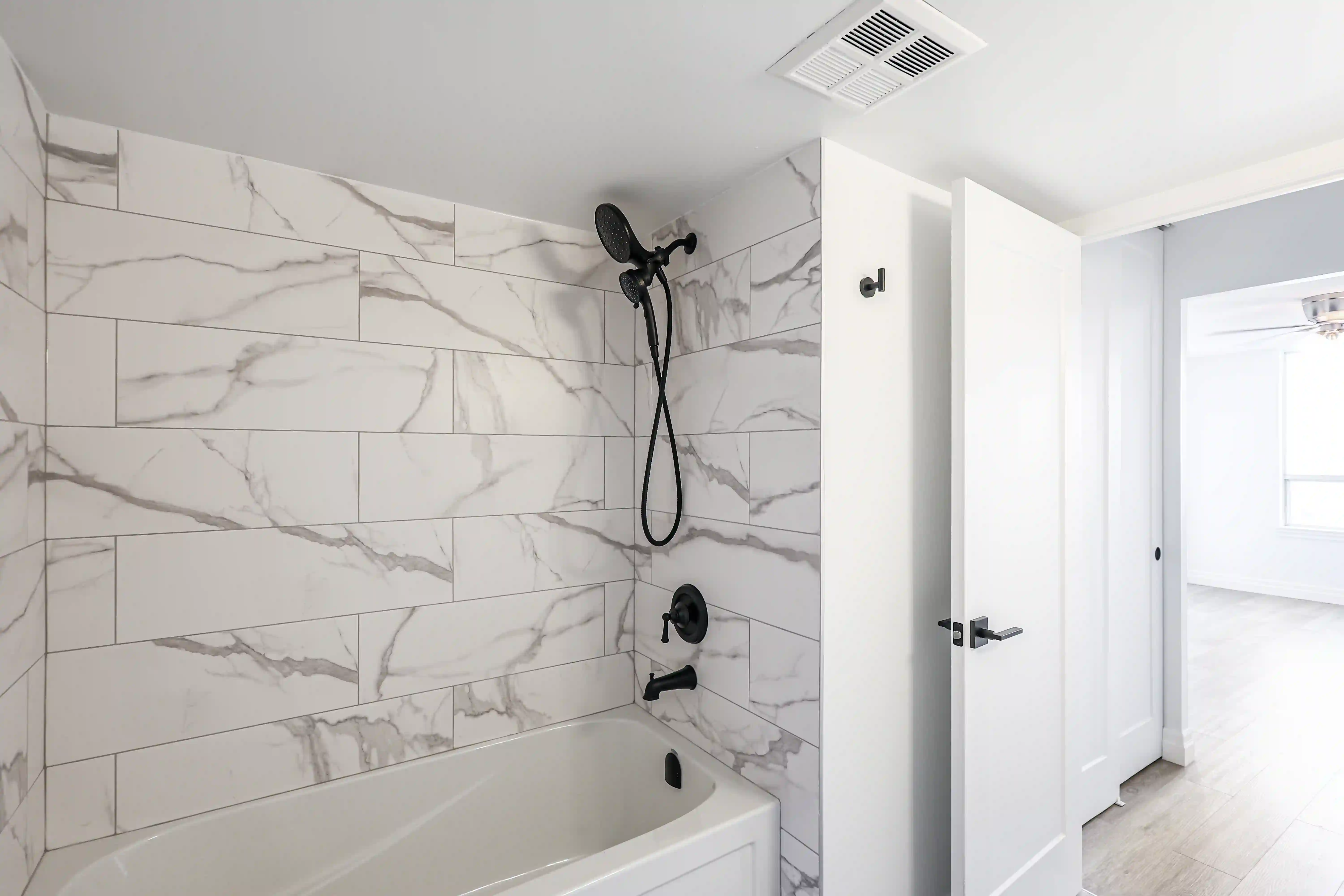 Marble shower wall and black fixture