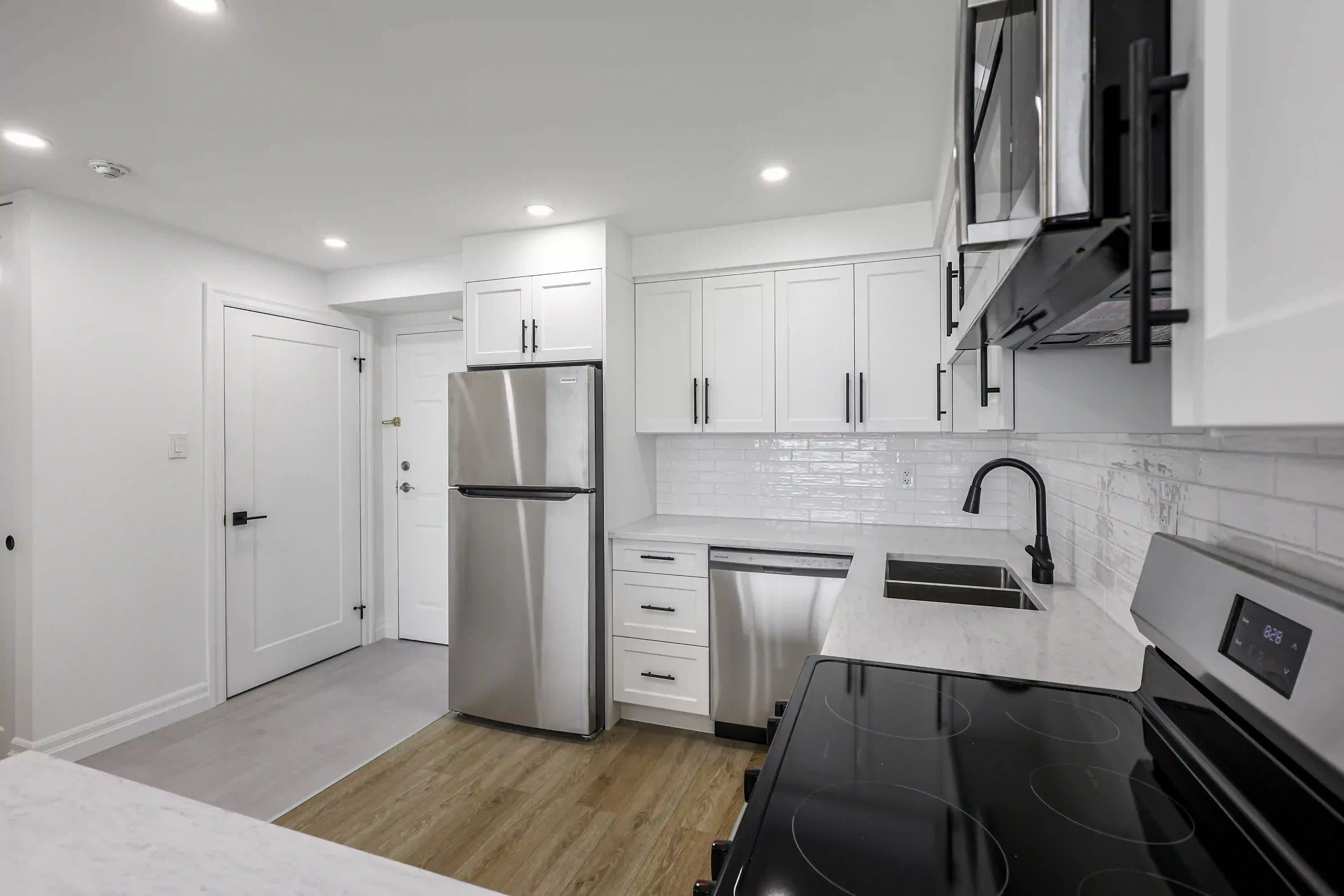 Galley kitchen with sink and range