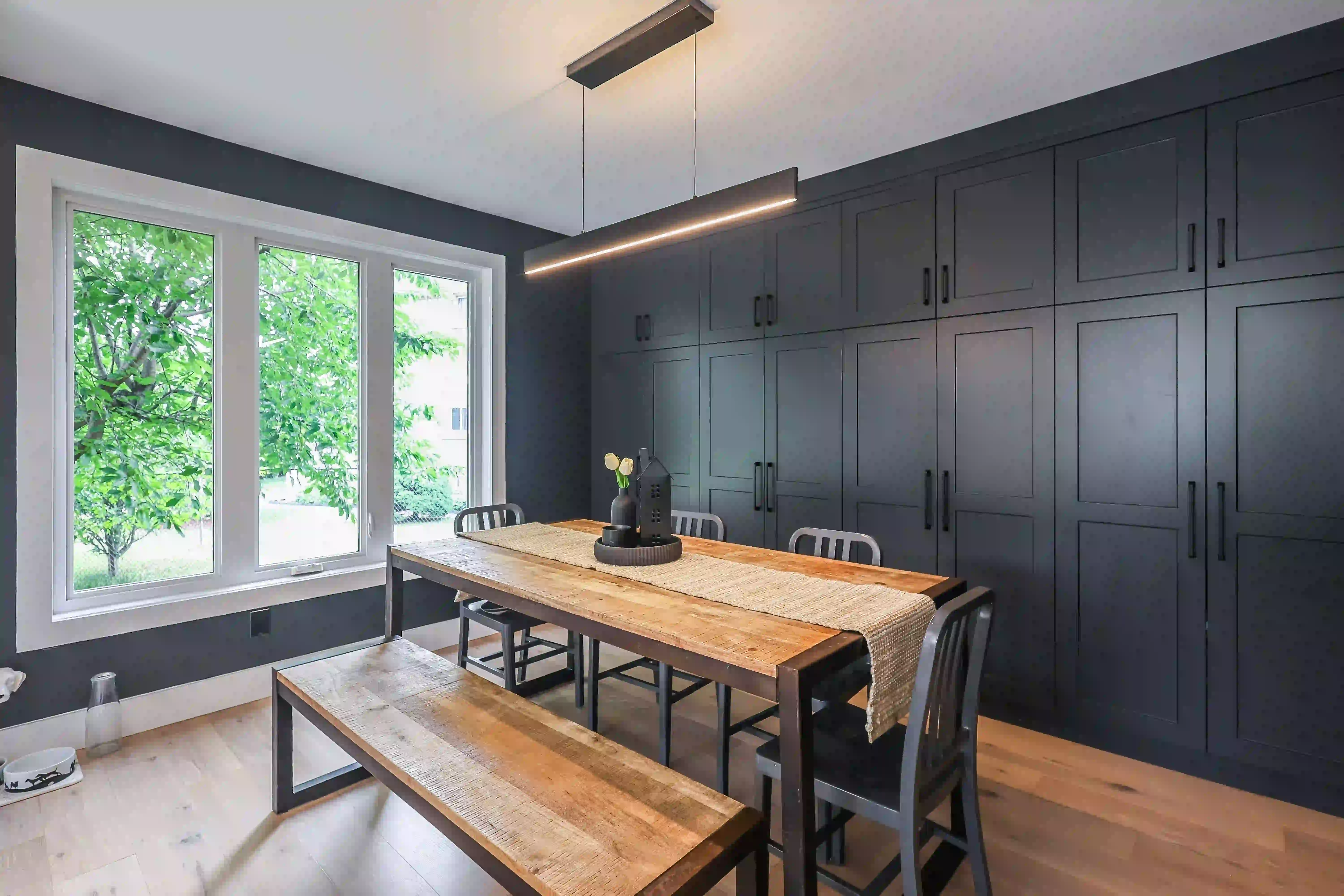 Dining room with window and dark cabinetry