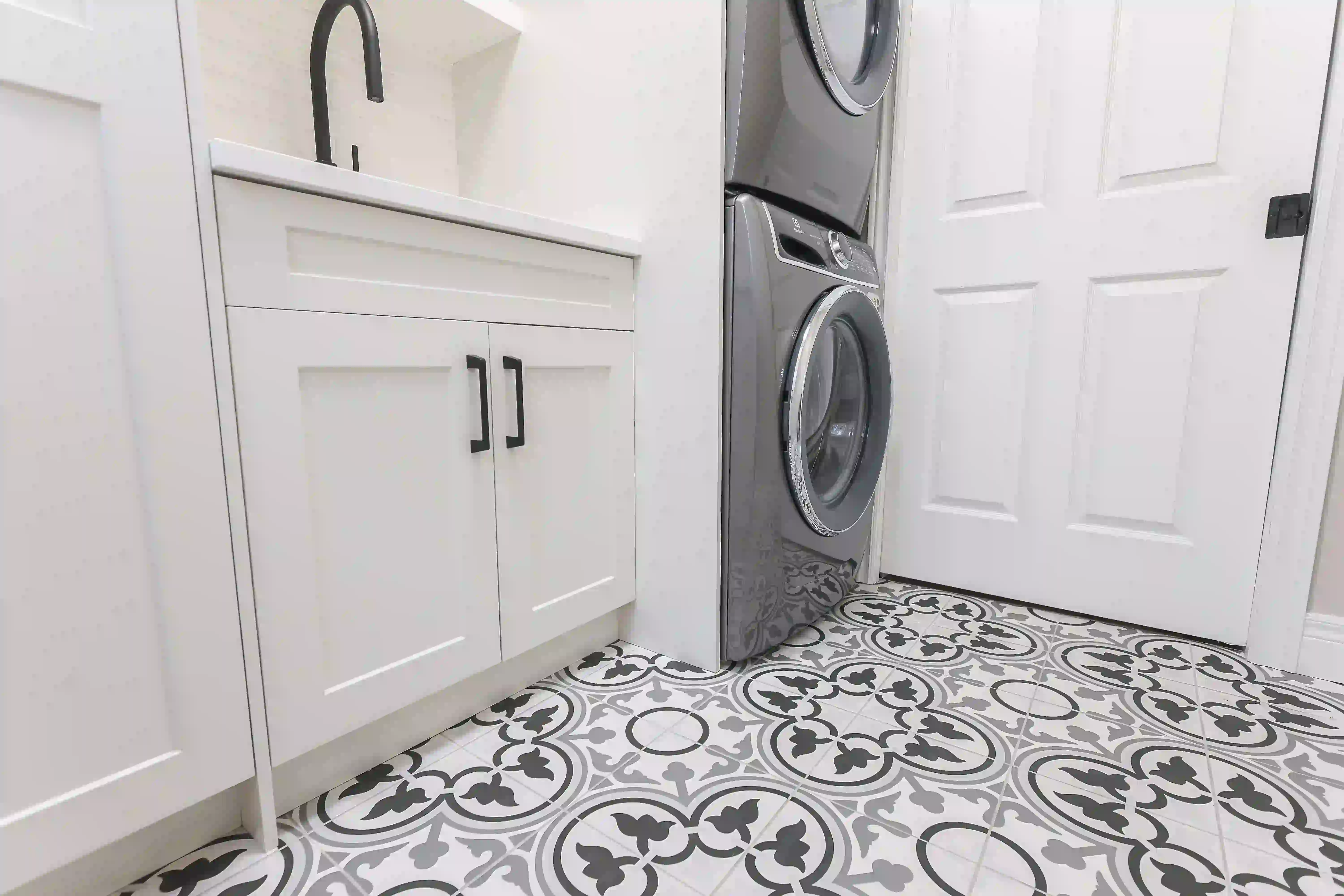 Laundry sink, cabinetry and appliances
