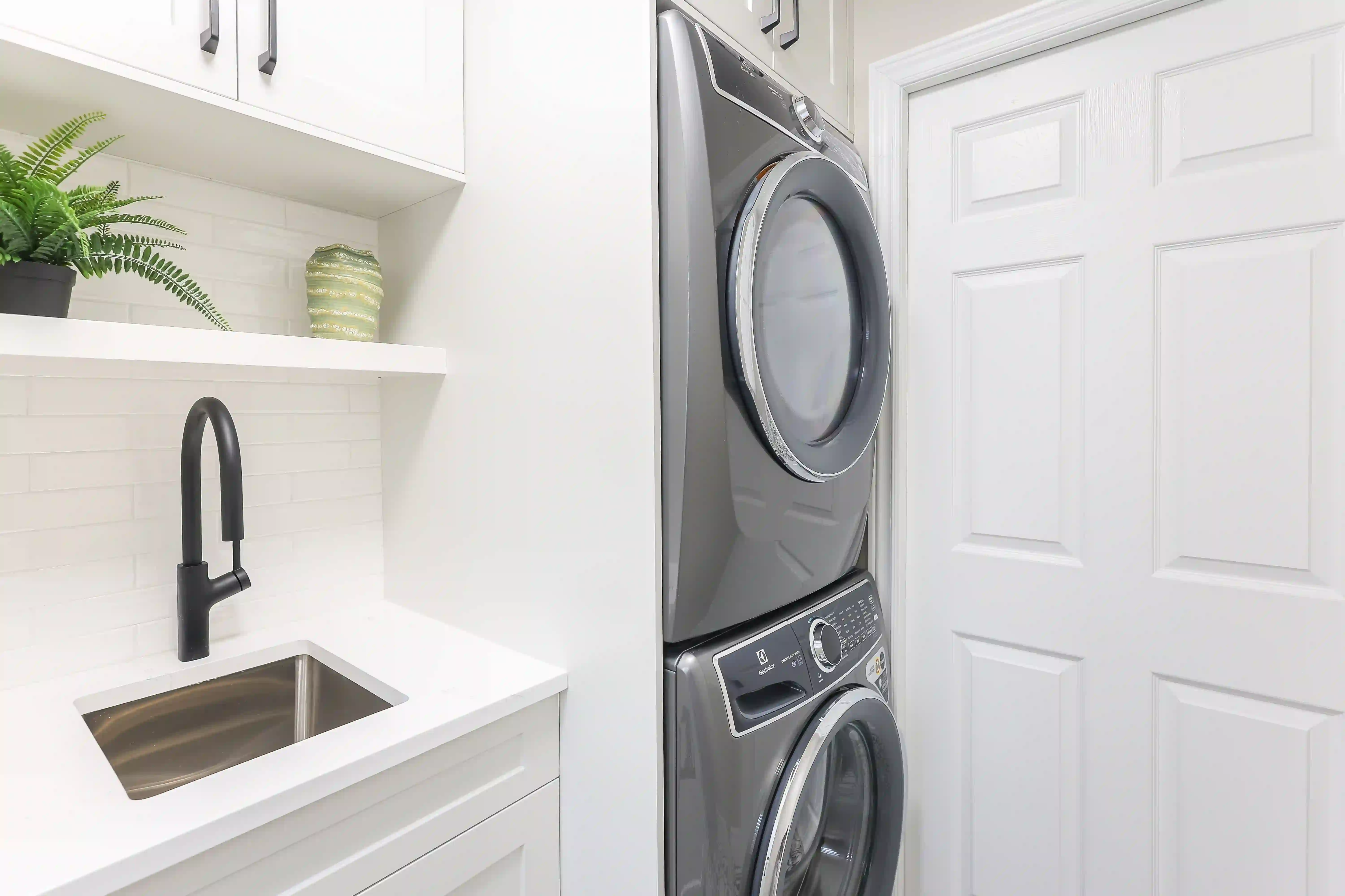 Laundry sink and stacked washer-dryer