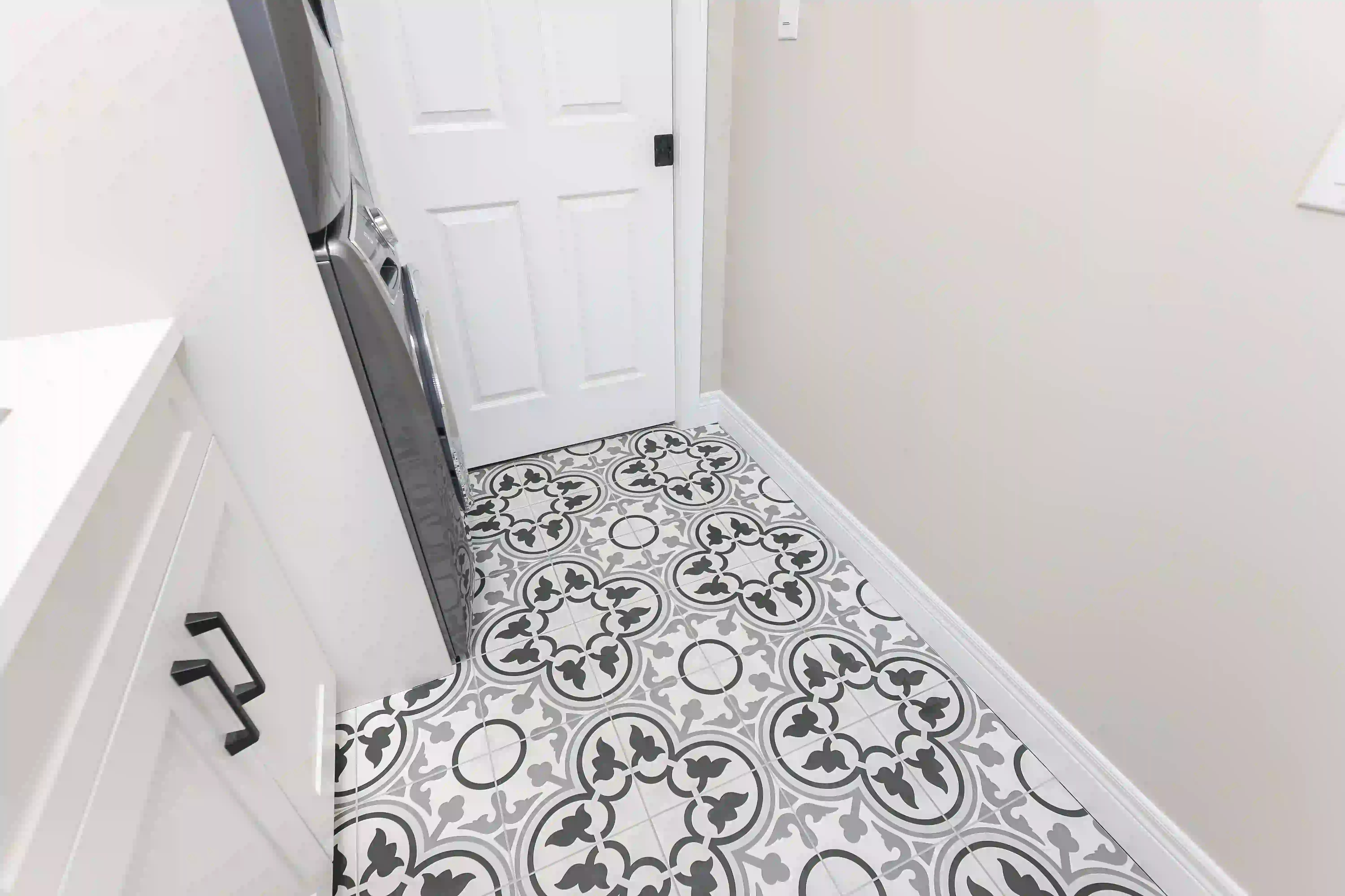 Laundry room with patterned tile floor