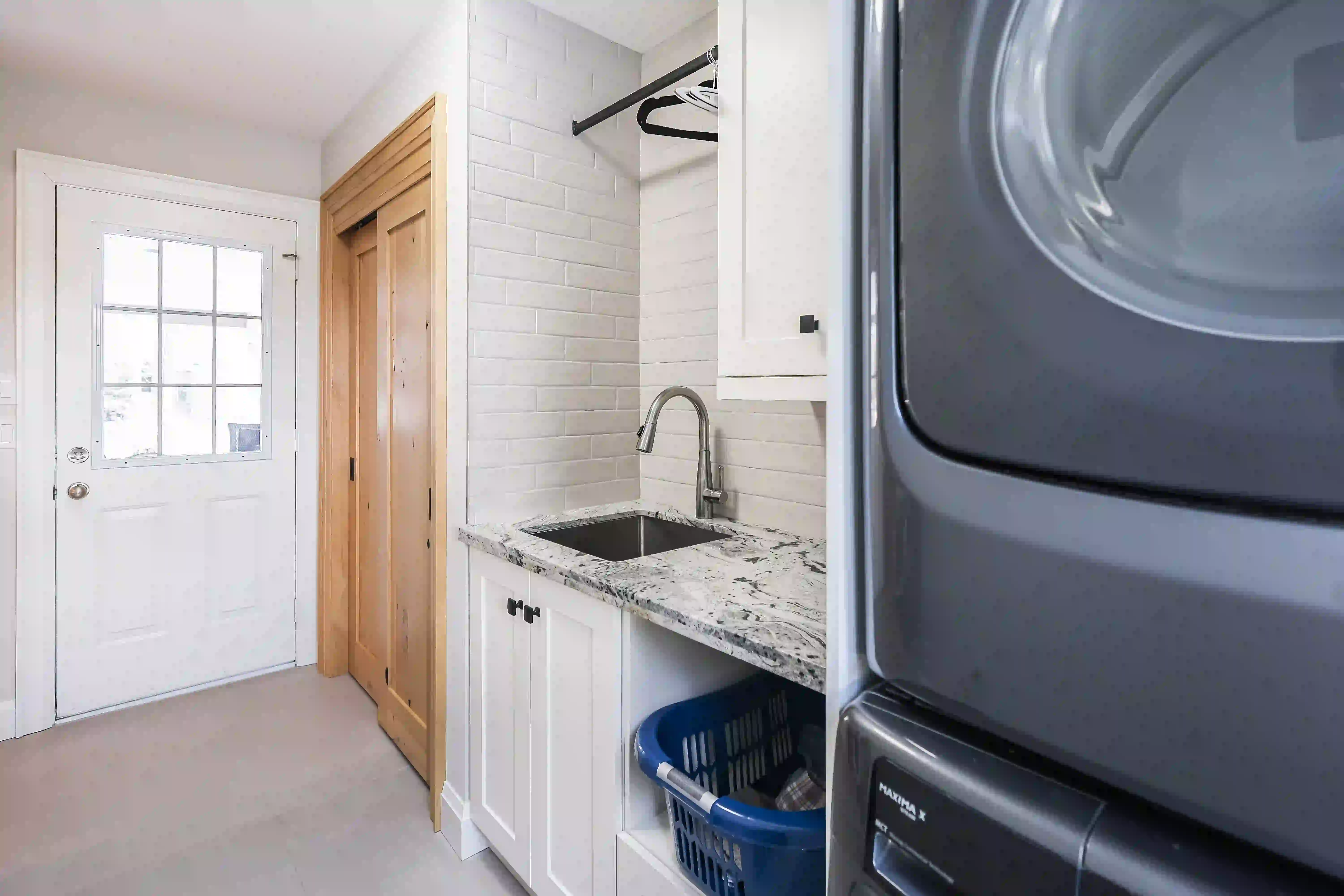 Laundry sink and stacked appliances
