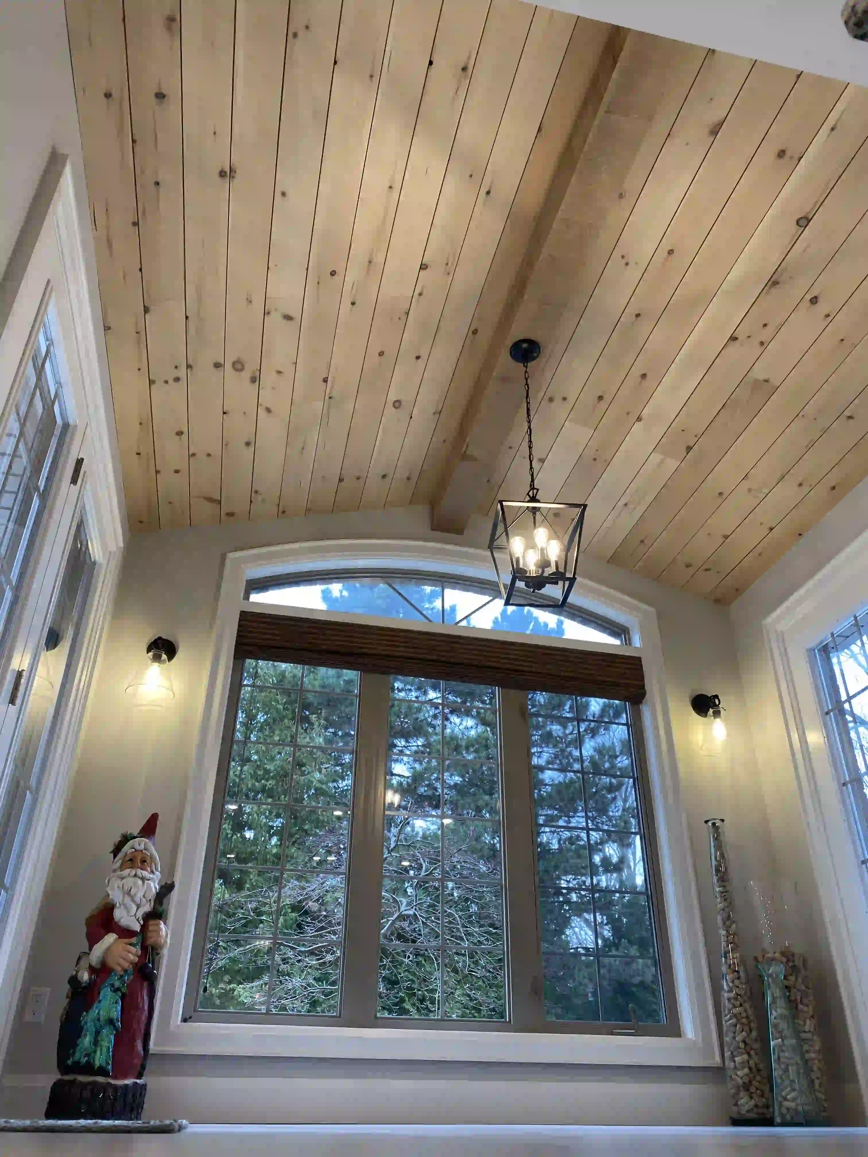 Wood ceiling and arched dining window