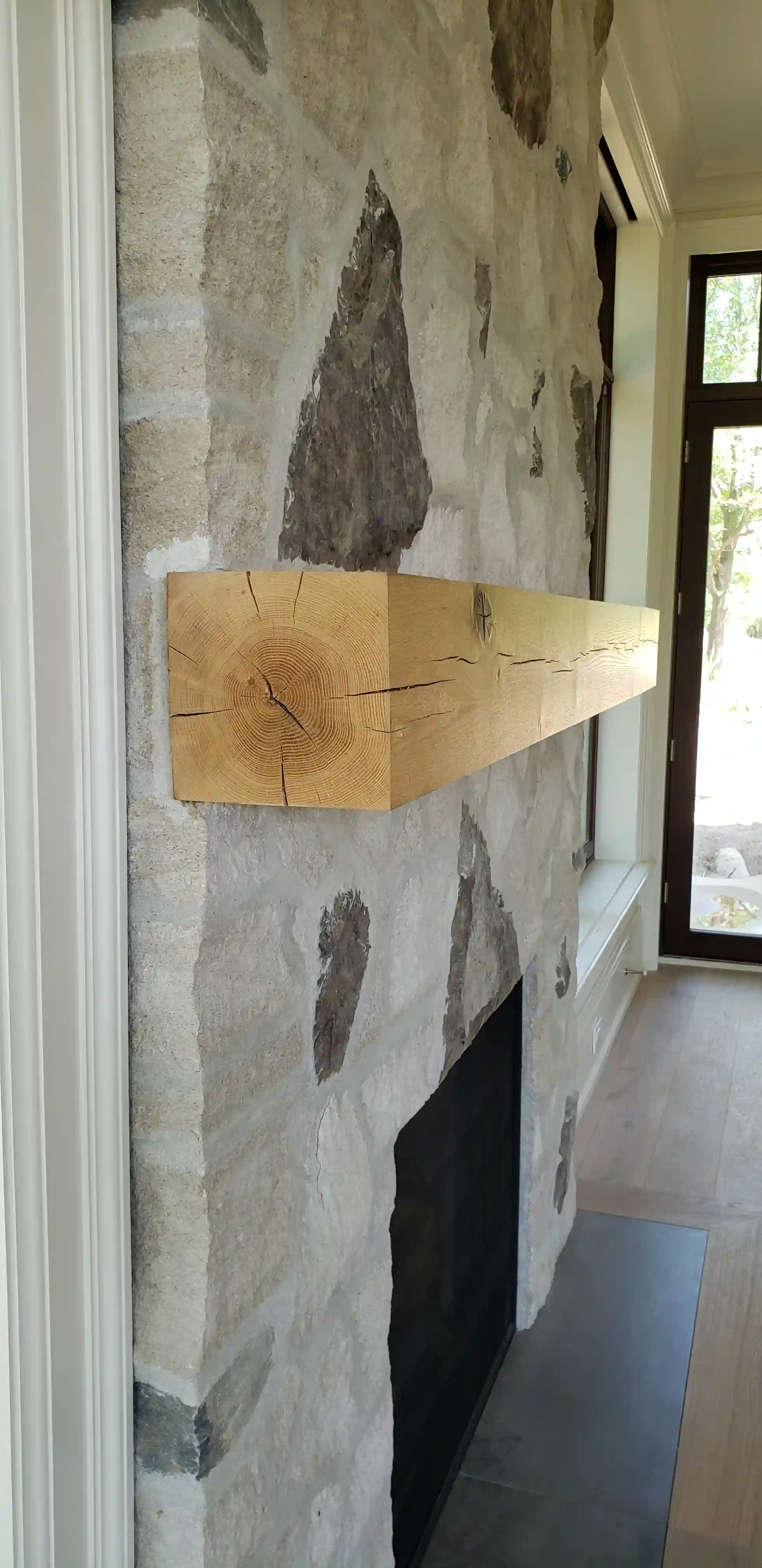 Wood mantle and stone fireplace detail
