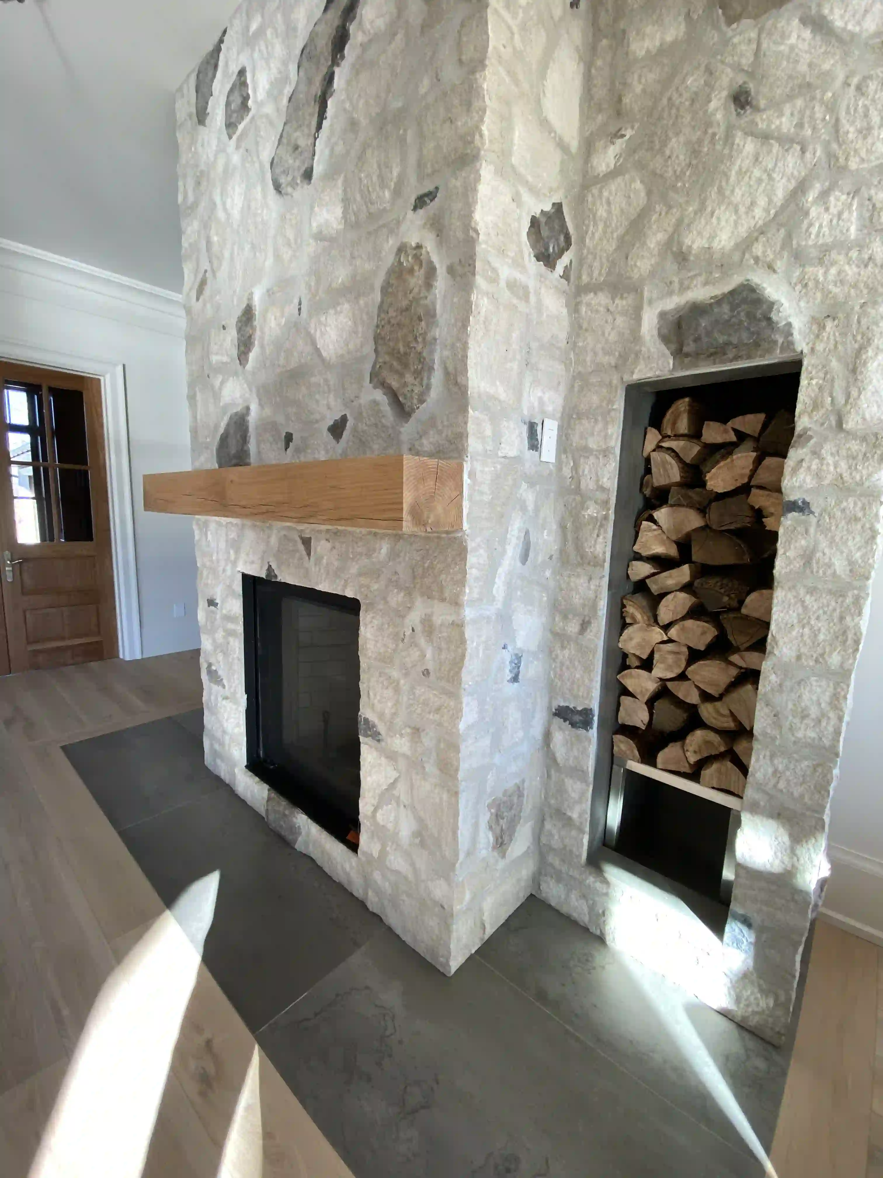 Stone fireplace with wood storage