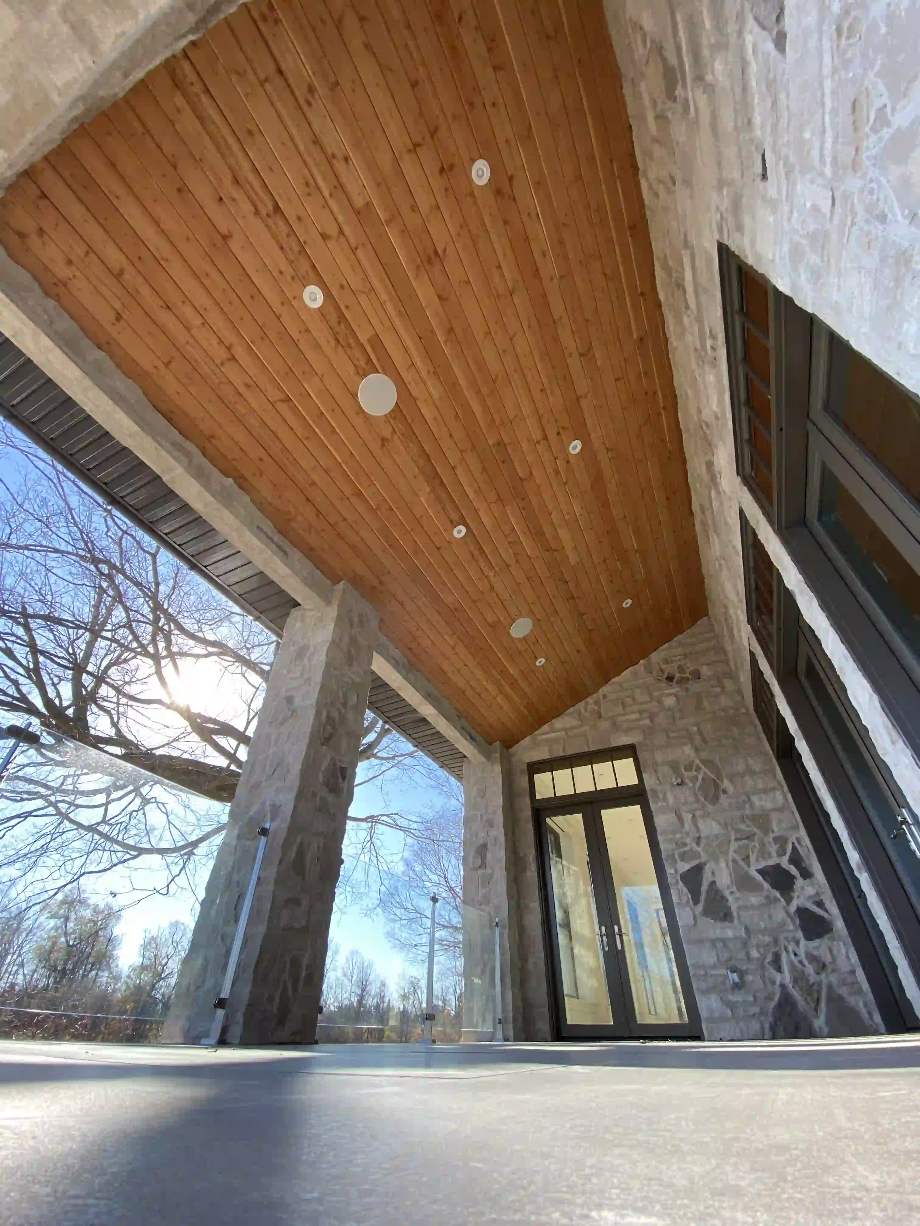 Covered porch ceiling and stone wall