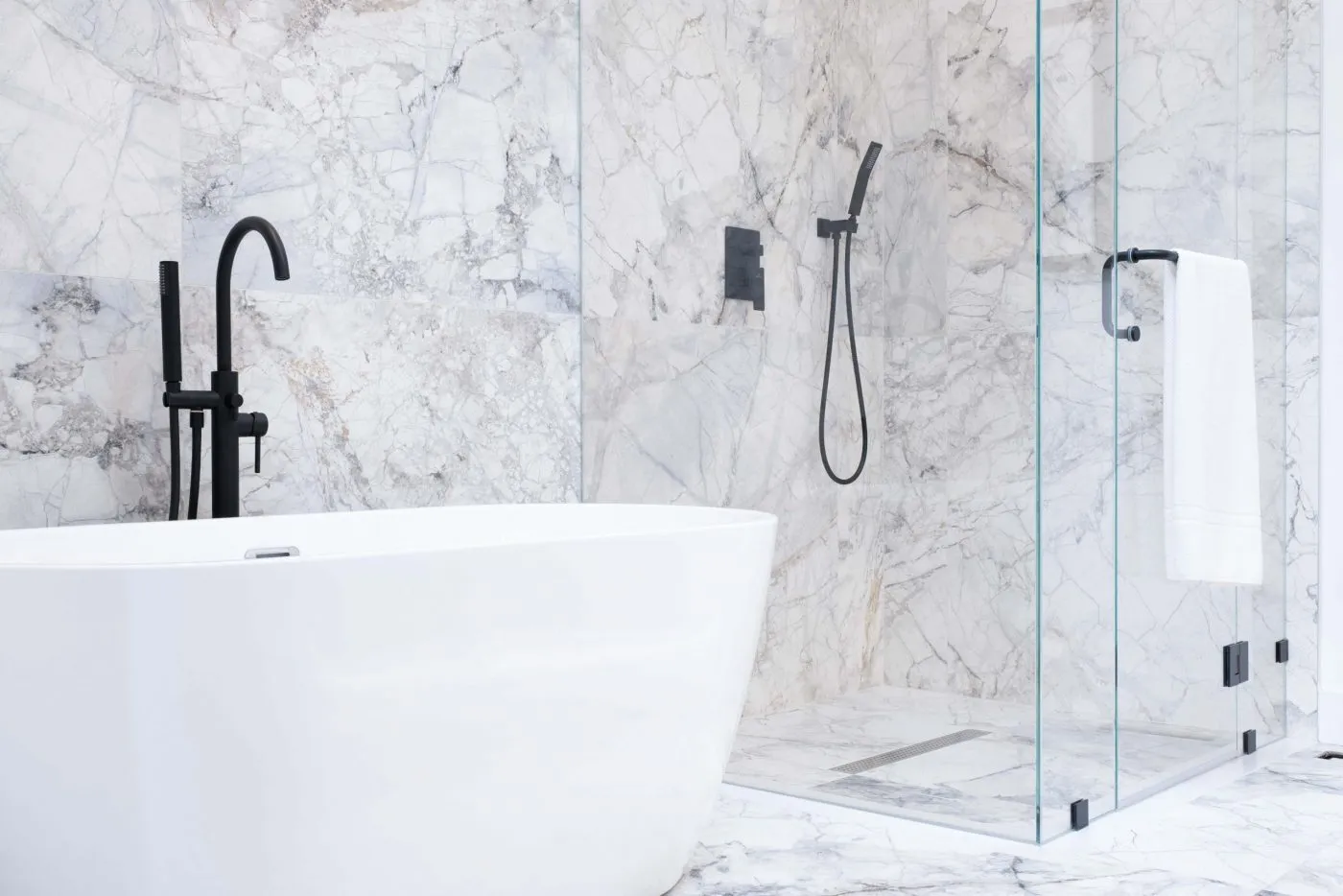 Marble ensuite with freestanding tub and glass shower