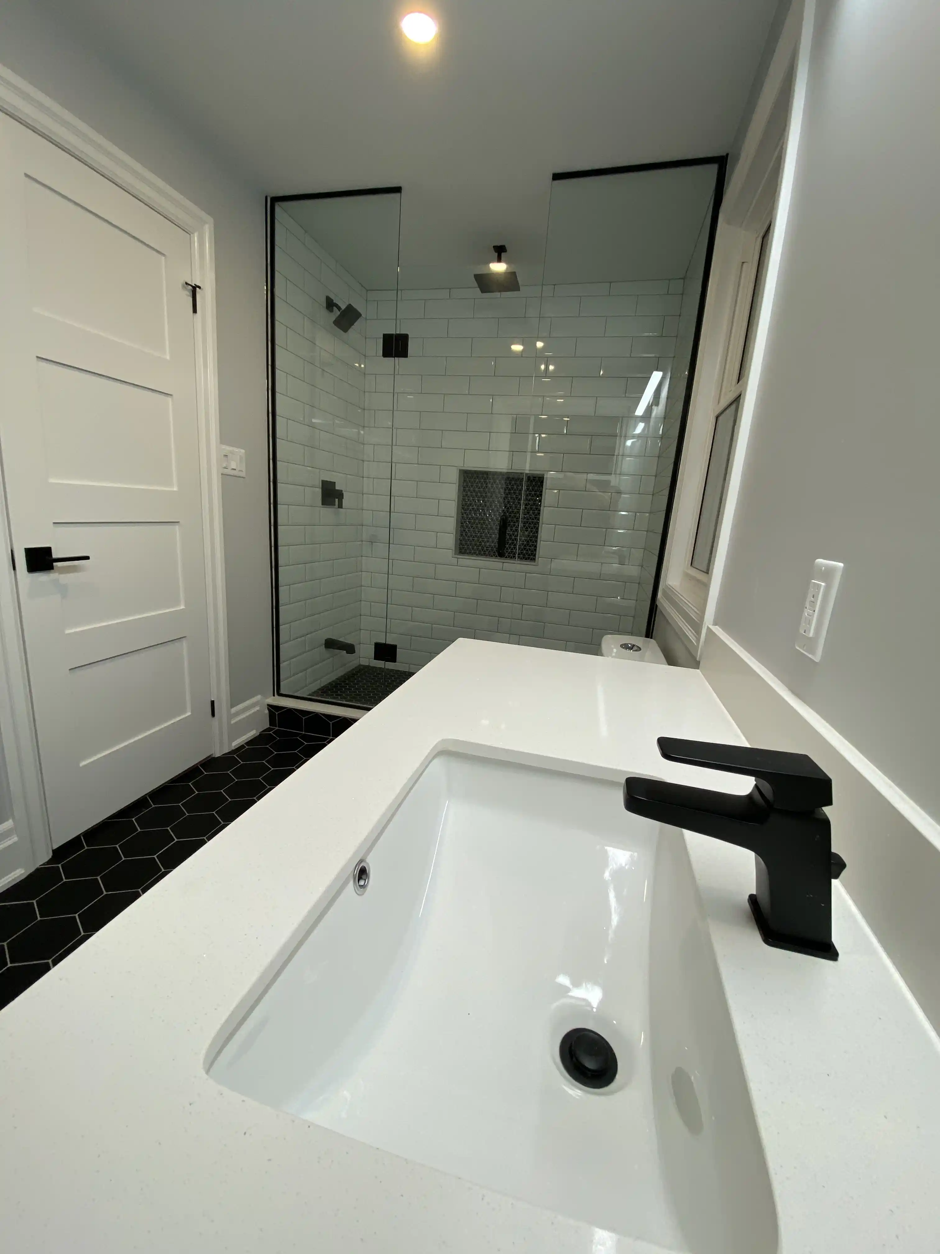 Bathroom vanity and glass shower view