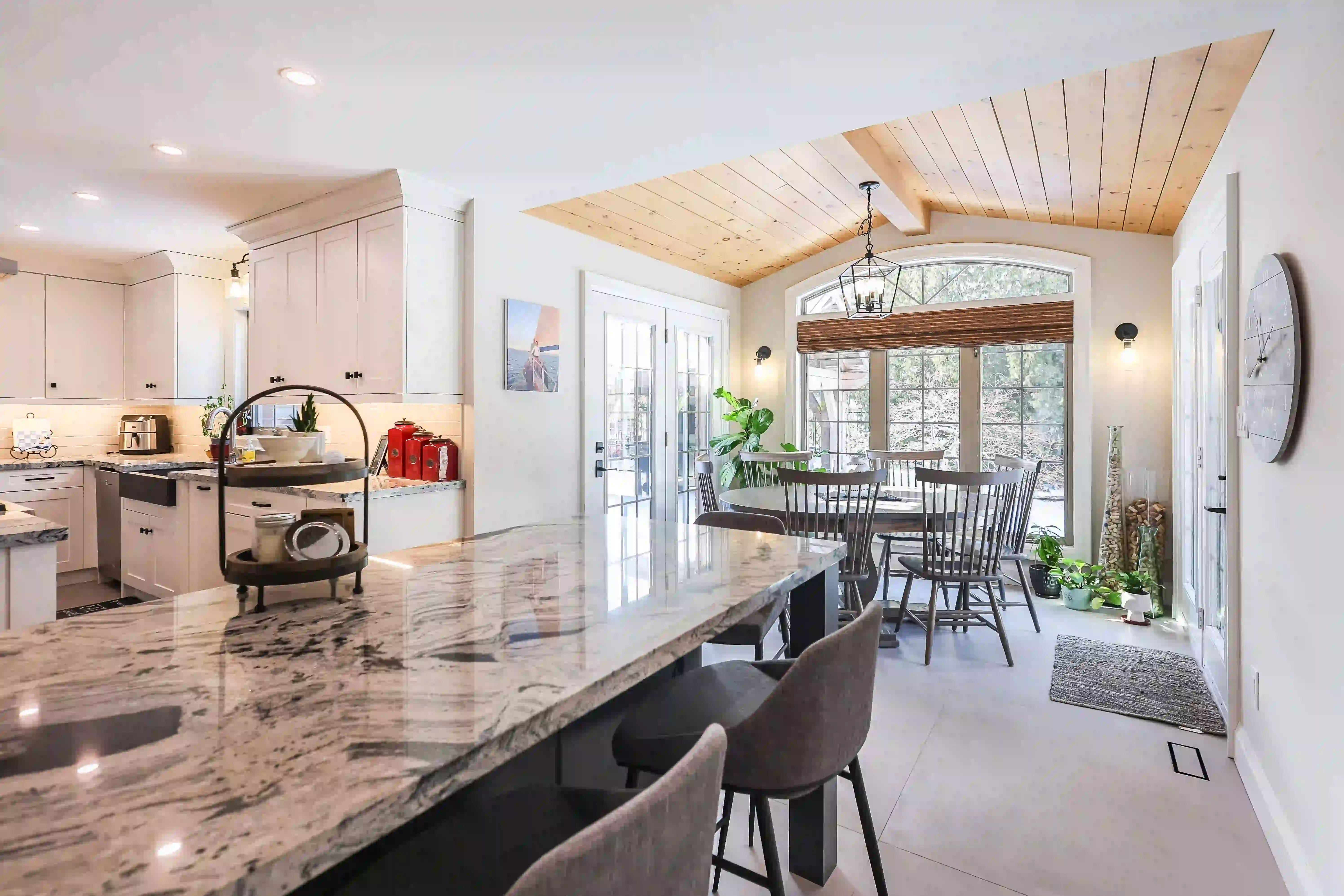Kitchen opening into sunroom seating