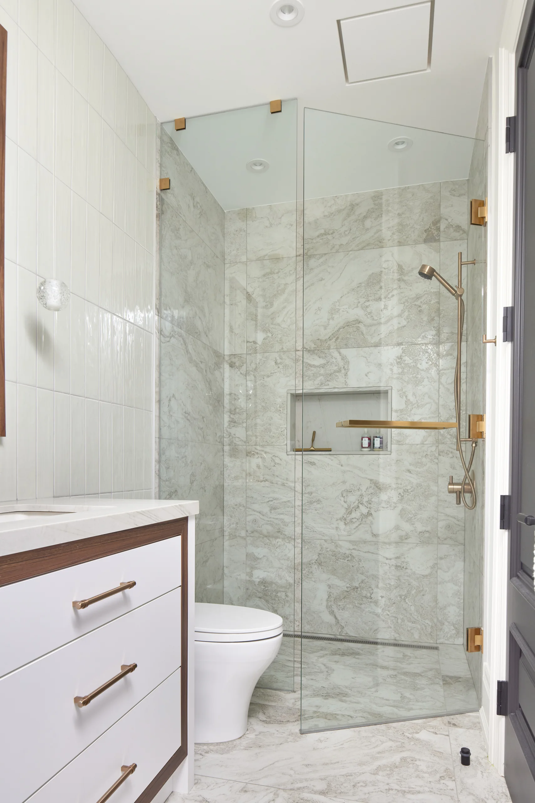 Glass shower with marble tile