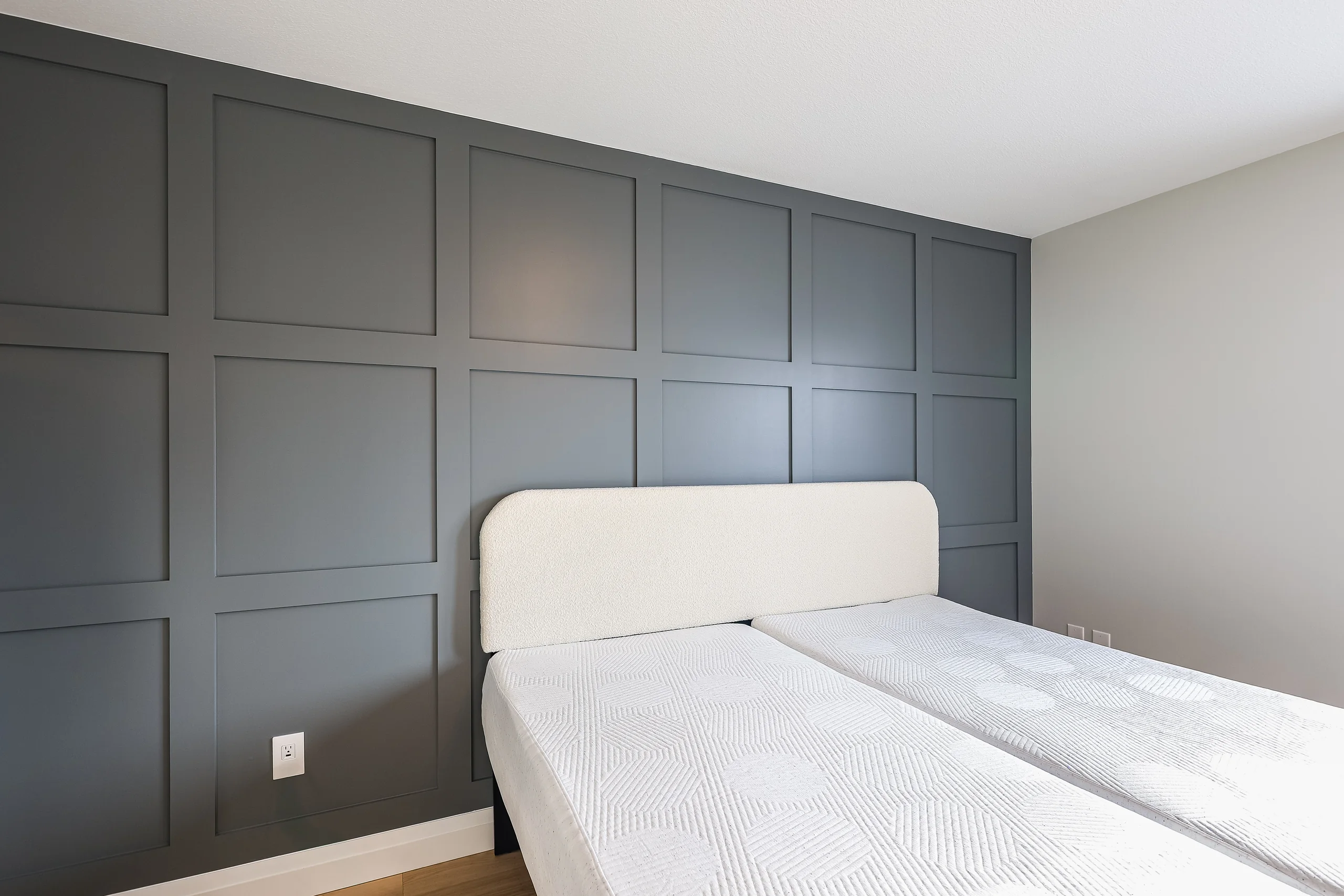Bedroom with paneled accent wall