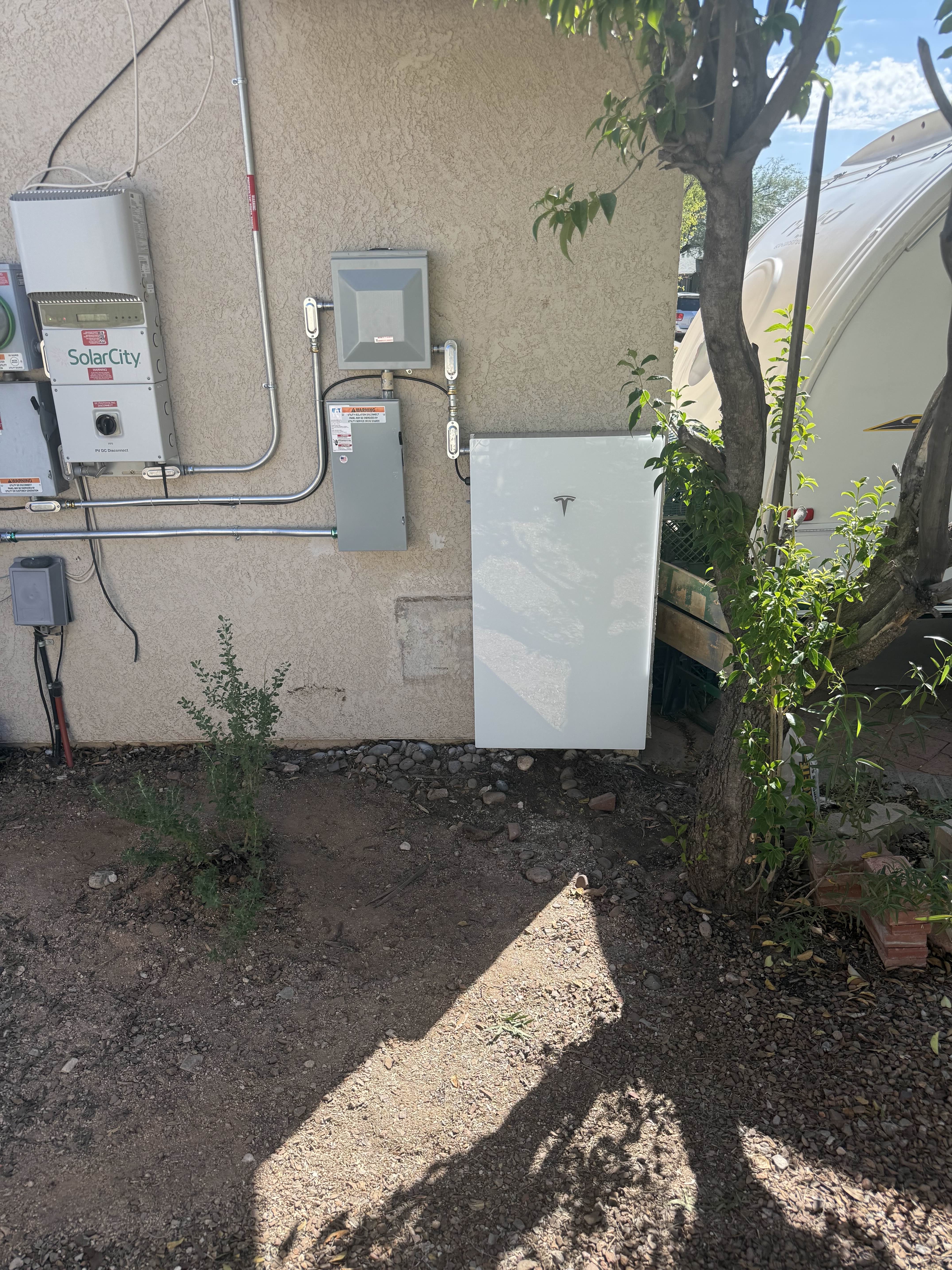 Battery storage unit installed outside near desert landscaping