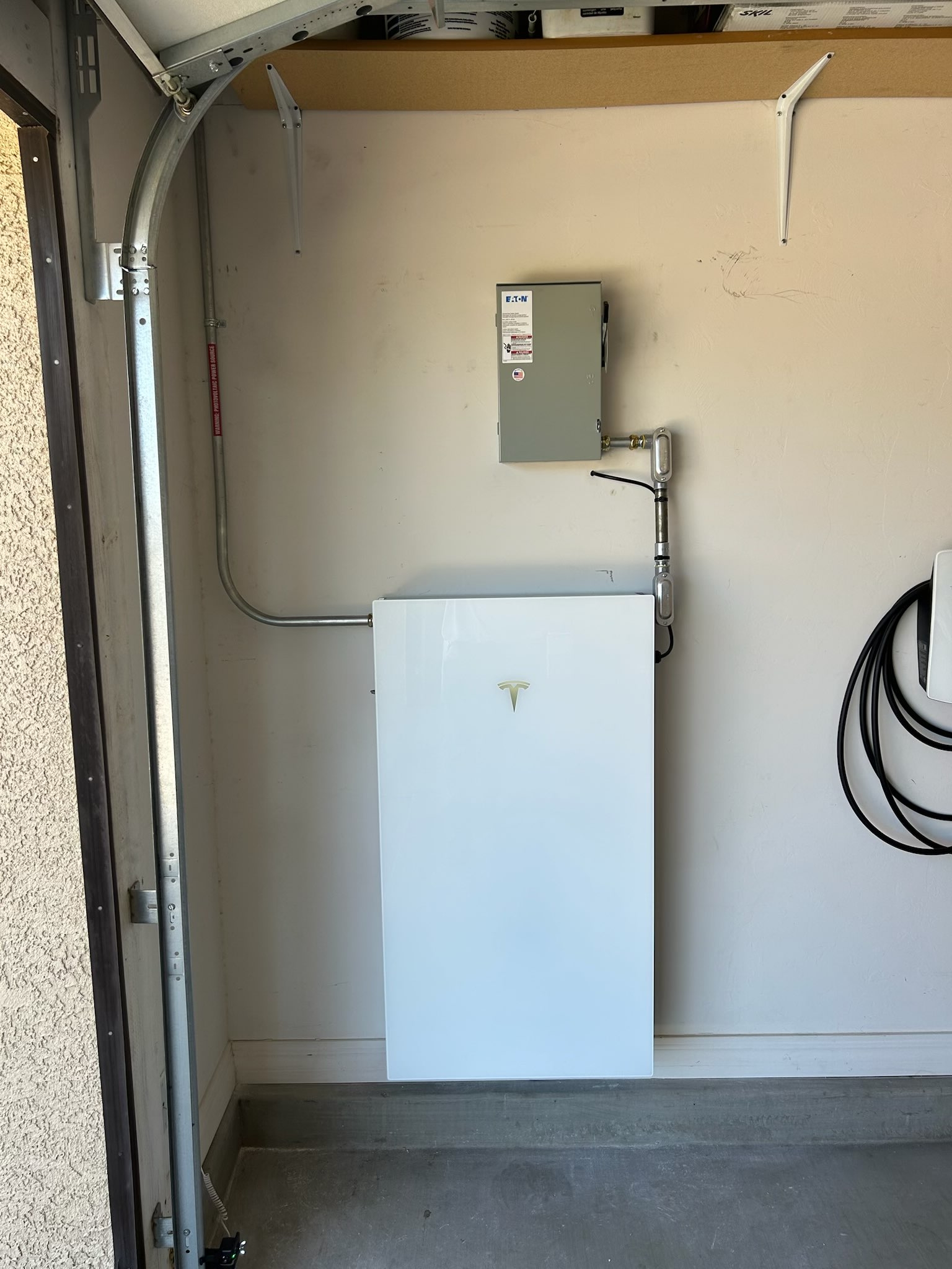 Single Tesla Powerwall battery installed in a garage