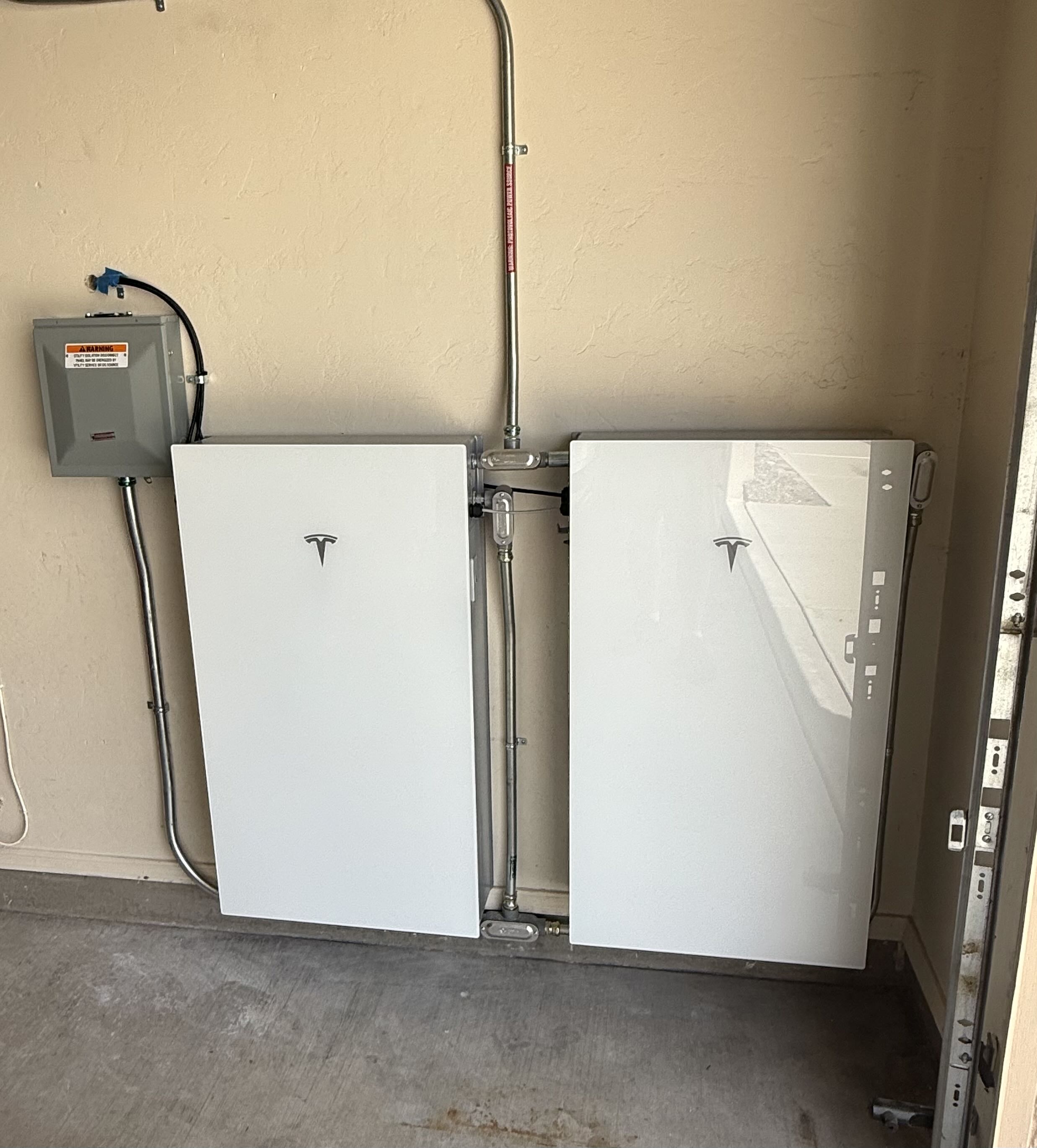 Two Tesla Powerwall batteries side by side