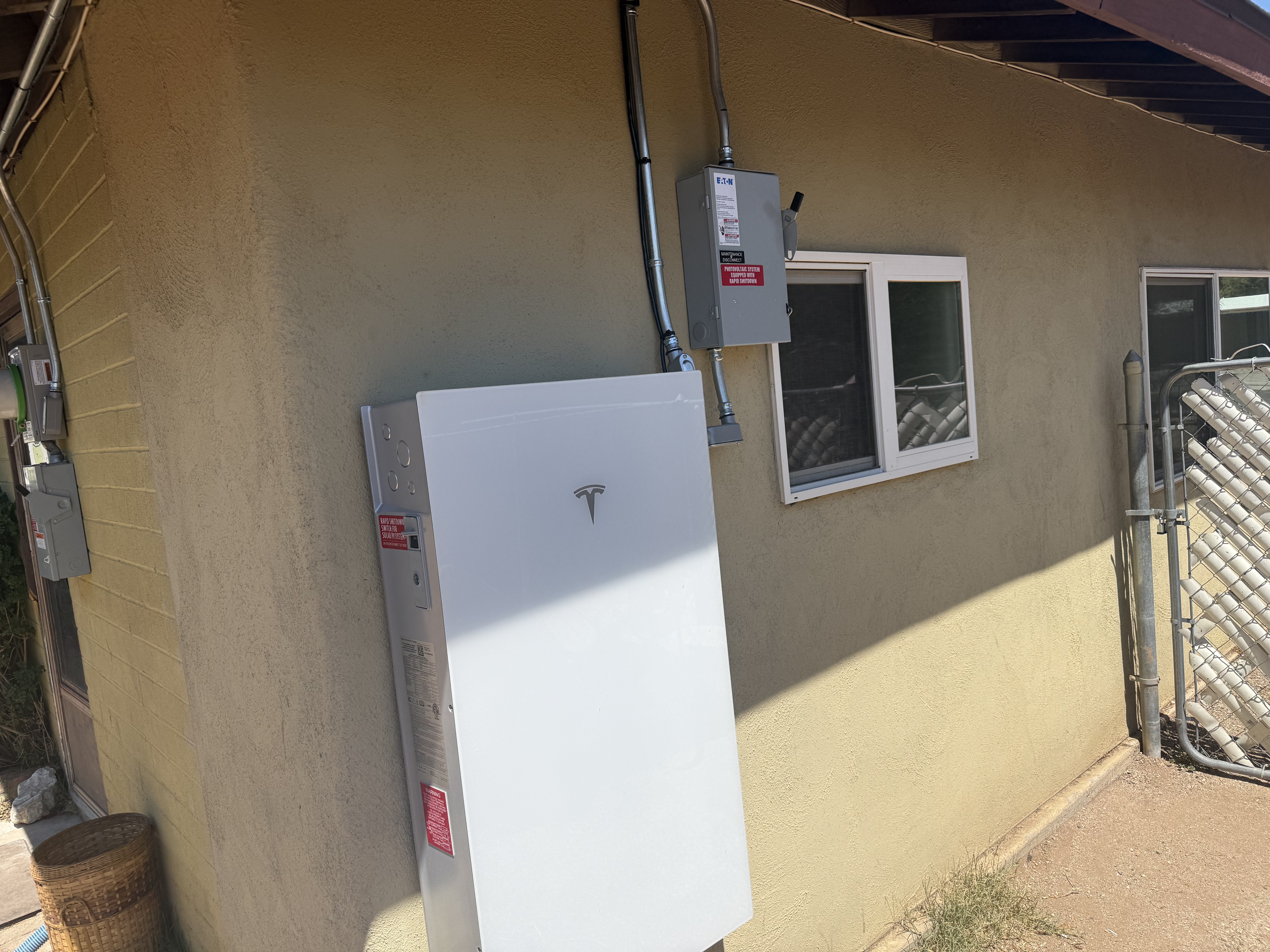 Tesla Powerwall mounted on an exterior wall