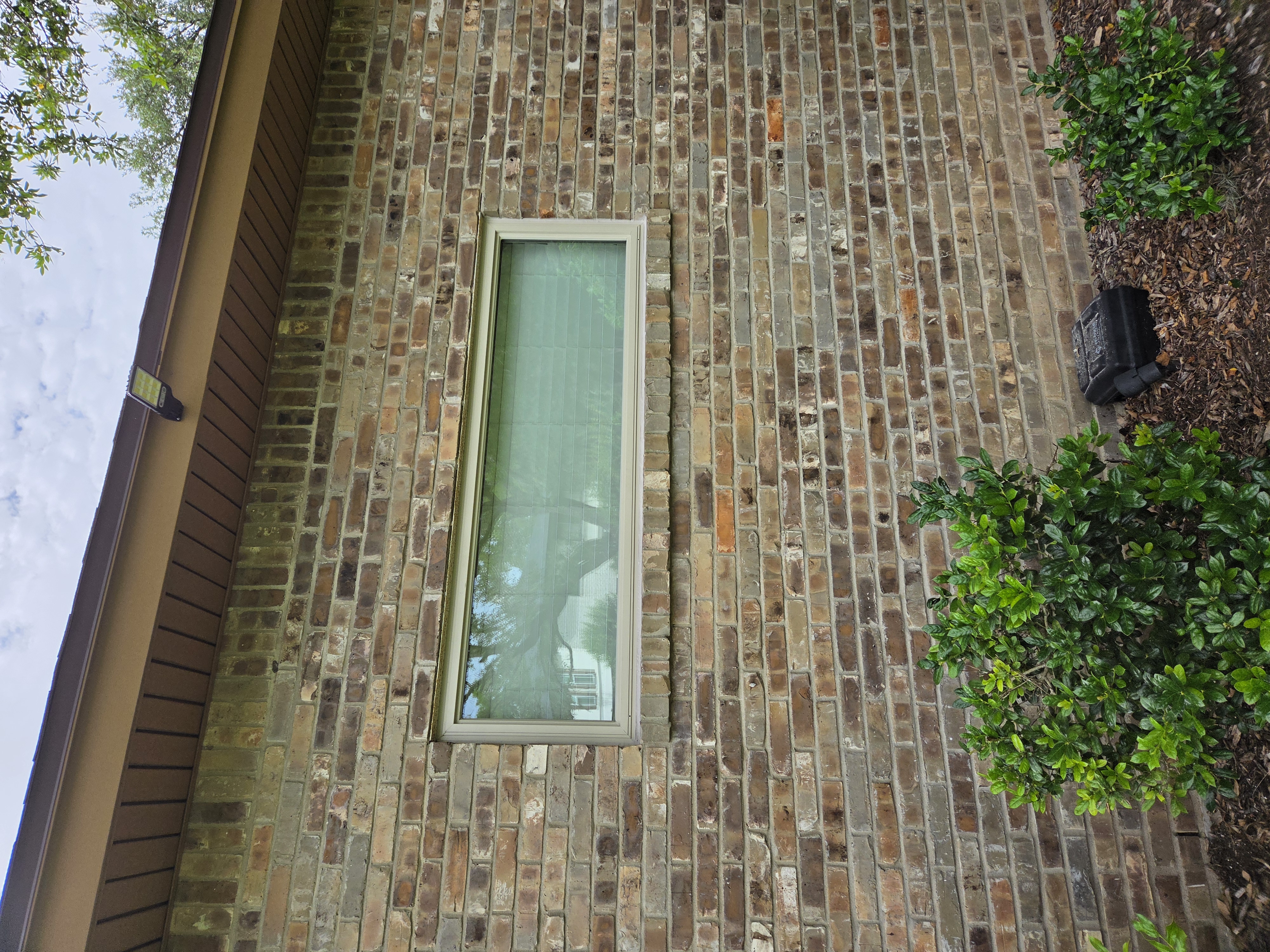 Newly installed replacement window in a brick San Antonio home