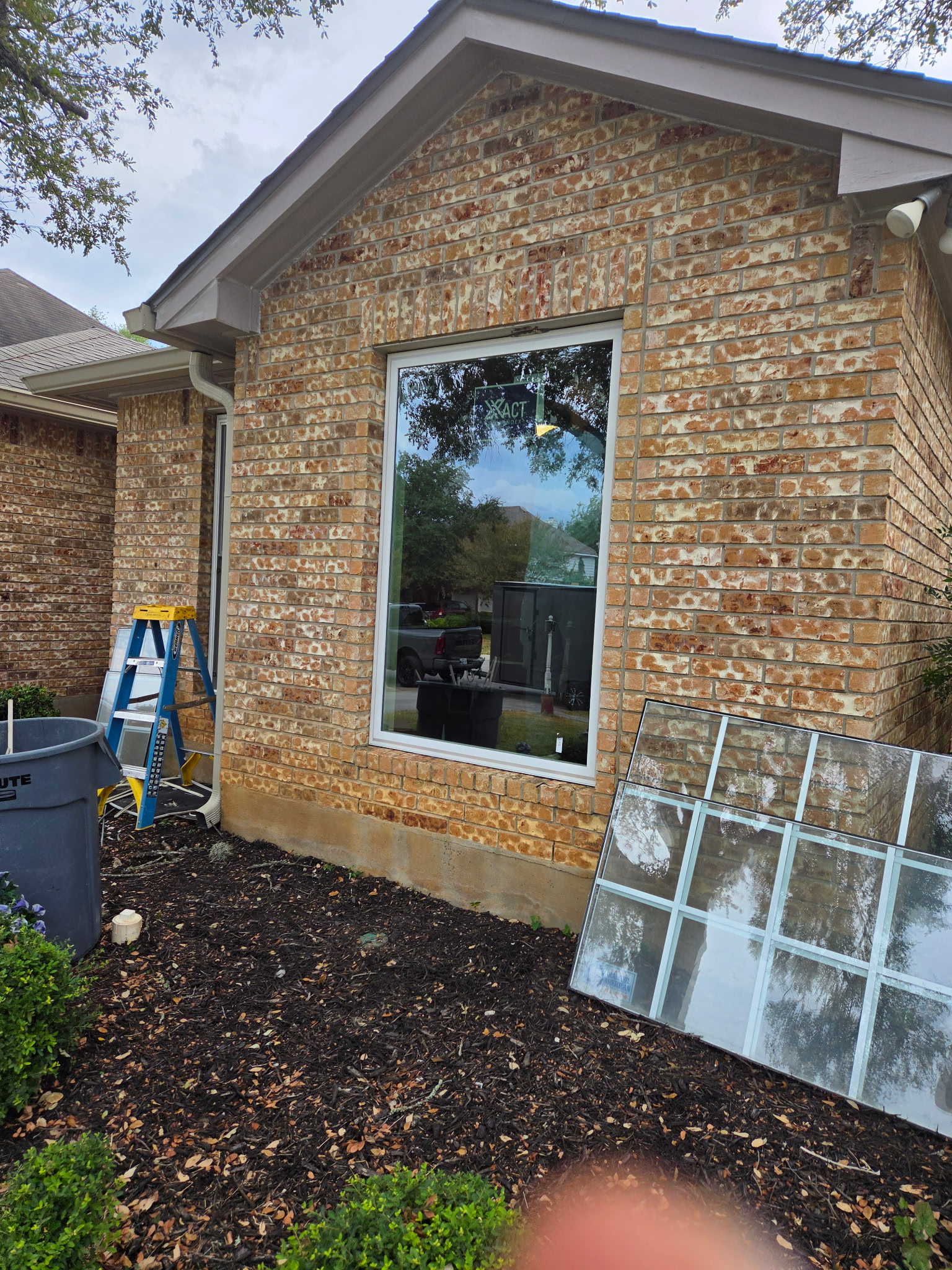 Newly installed picture window in a brick San Antonio home