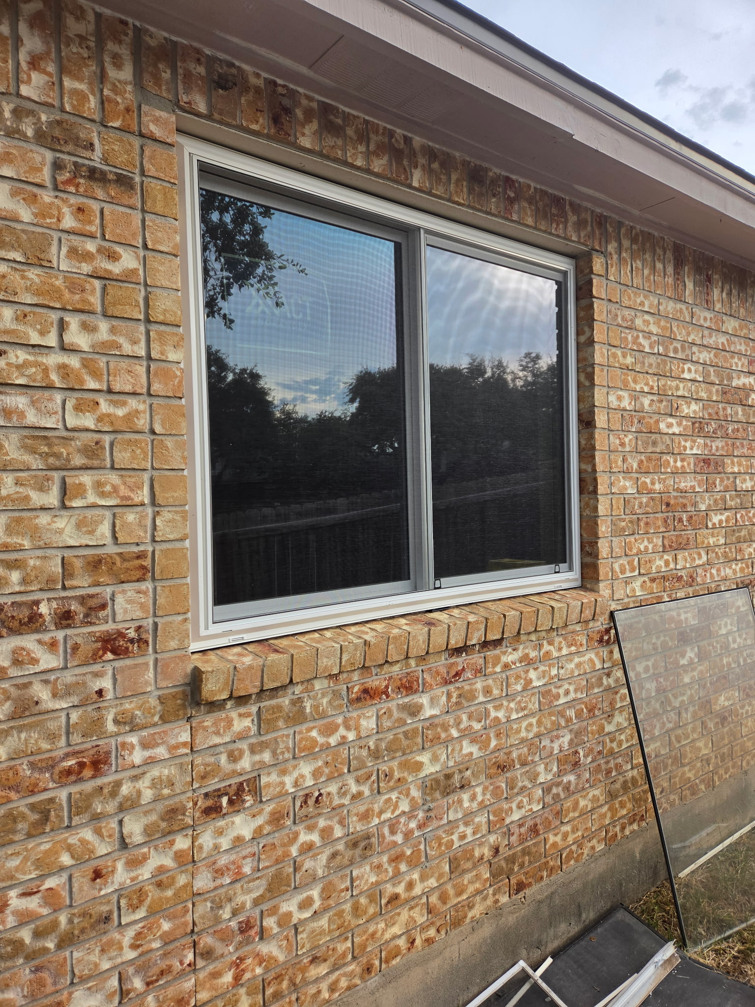 Newly installed double window in a brick San Antonio home