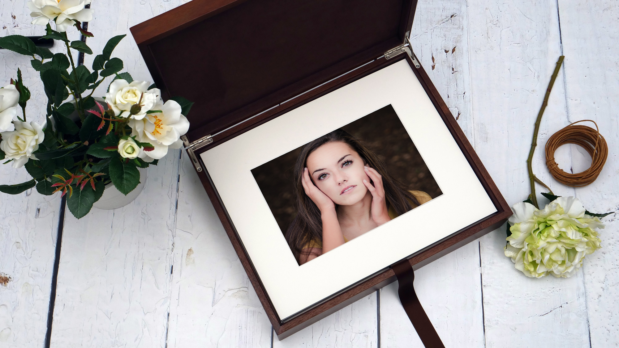 a photo of a folio box with a matted image of a high school senior girl with her hands on her face