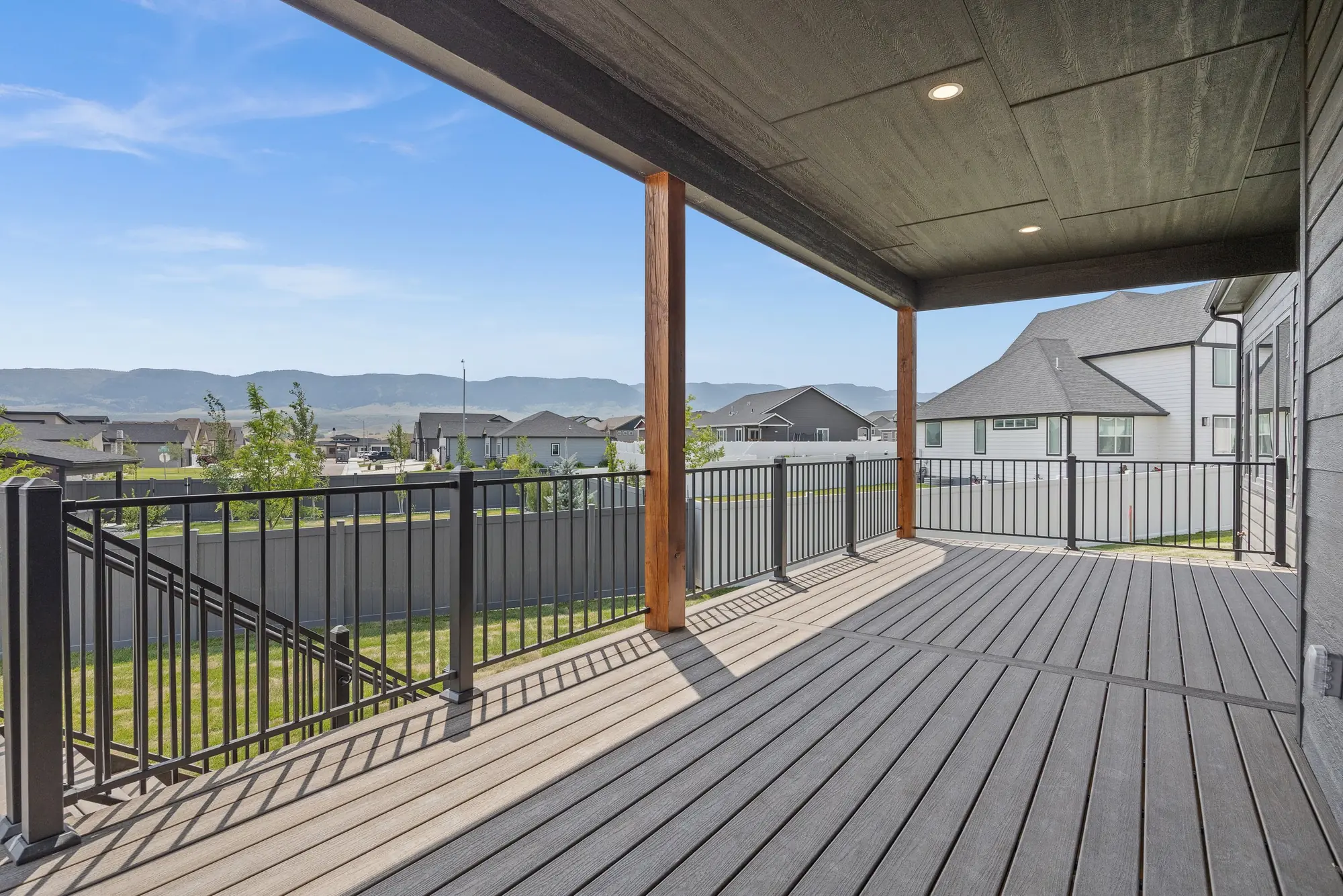 Covered back deck of a new custom home in Casper, WY with views of the surrounding hills