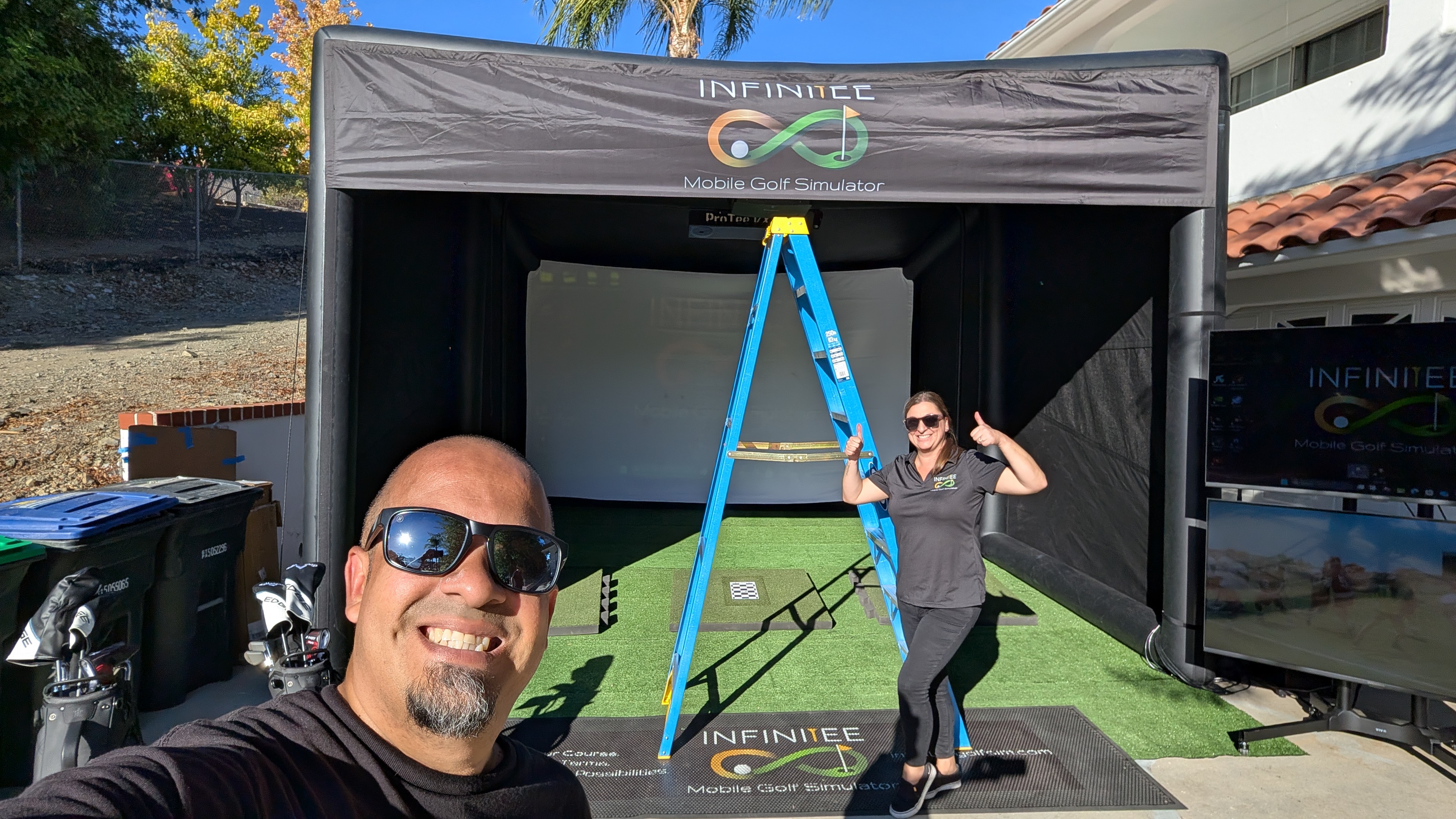 InfiniTEE crew setting up the simulator at a backyard event, Menifee CA