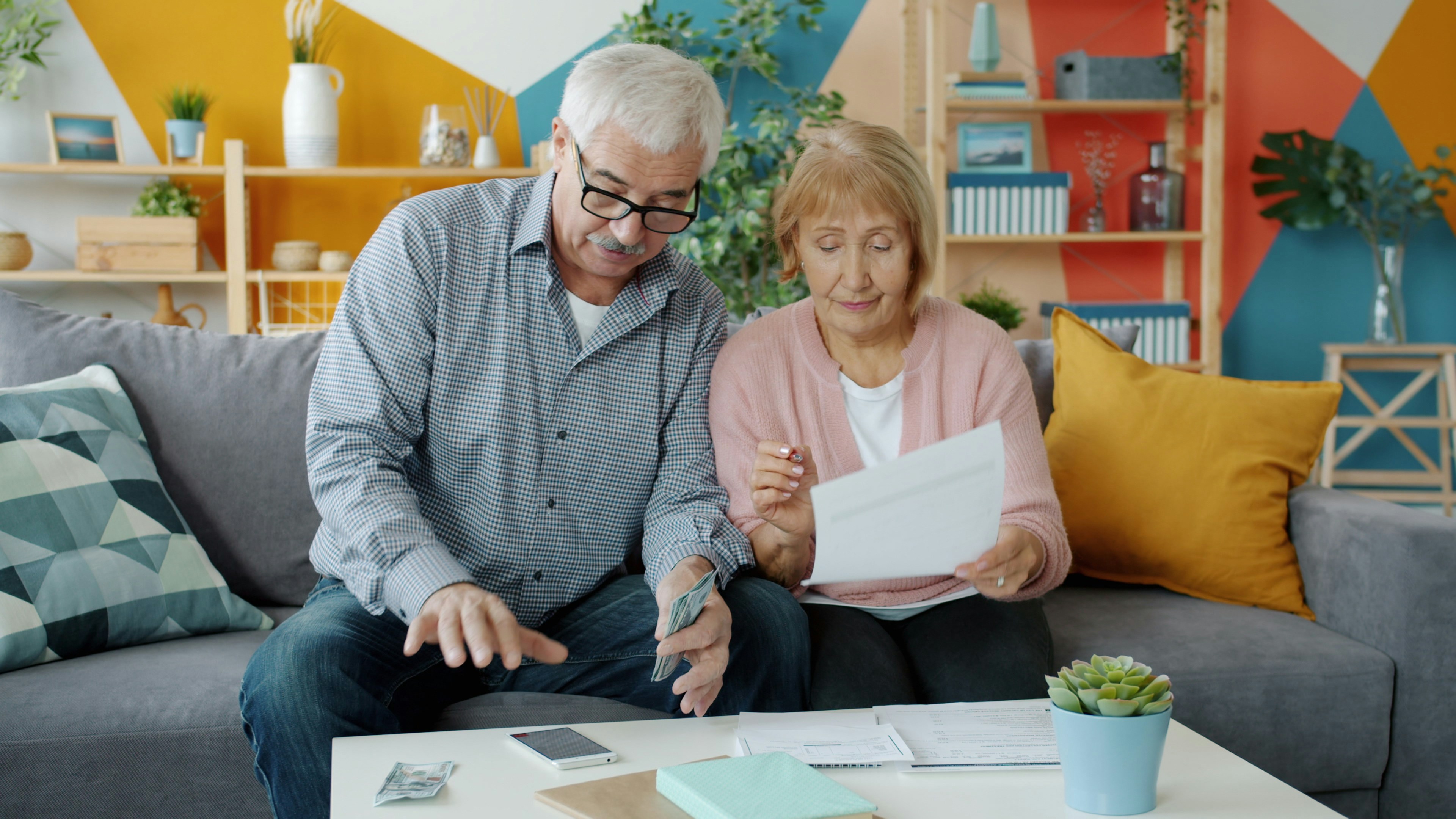 An elderly couple reviewing their finances together at home
