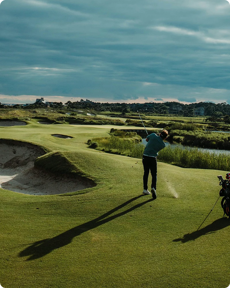 man golfing in the evening at a nice resort