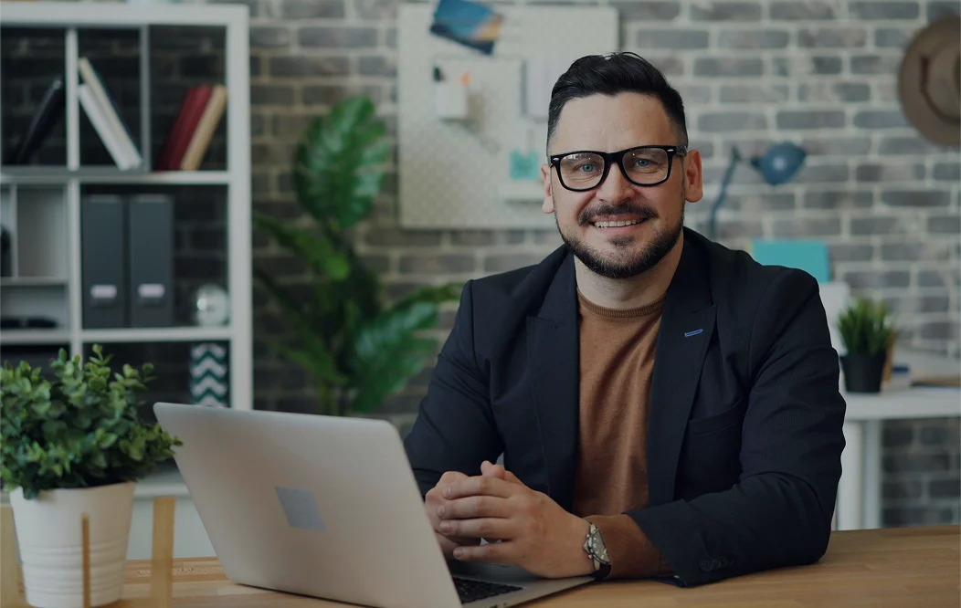 professional man sitting in front of laptop in office