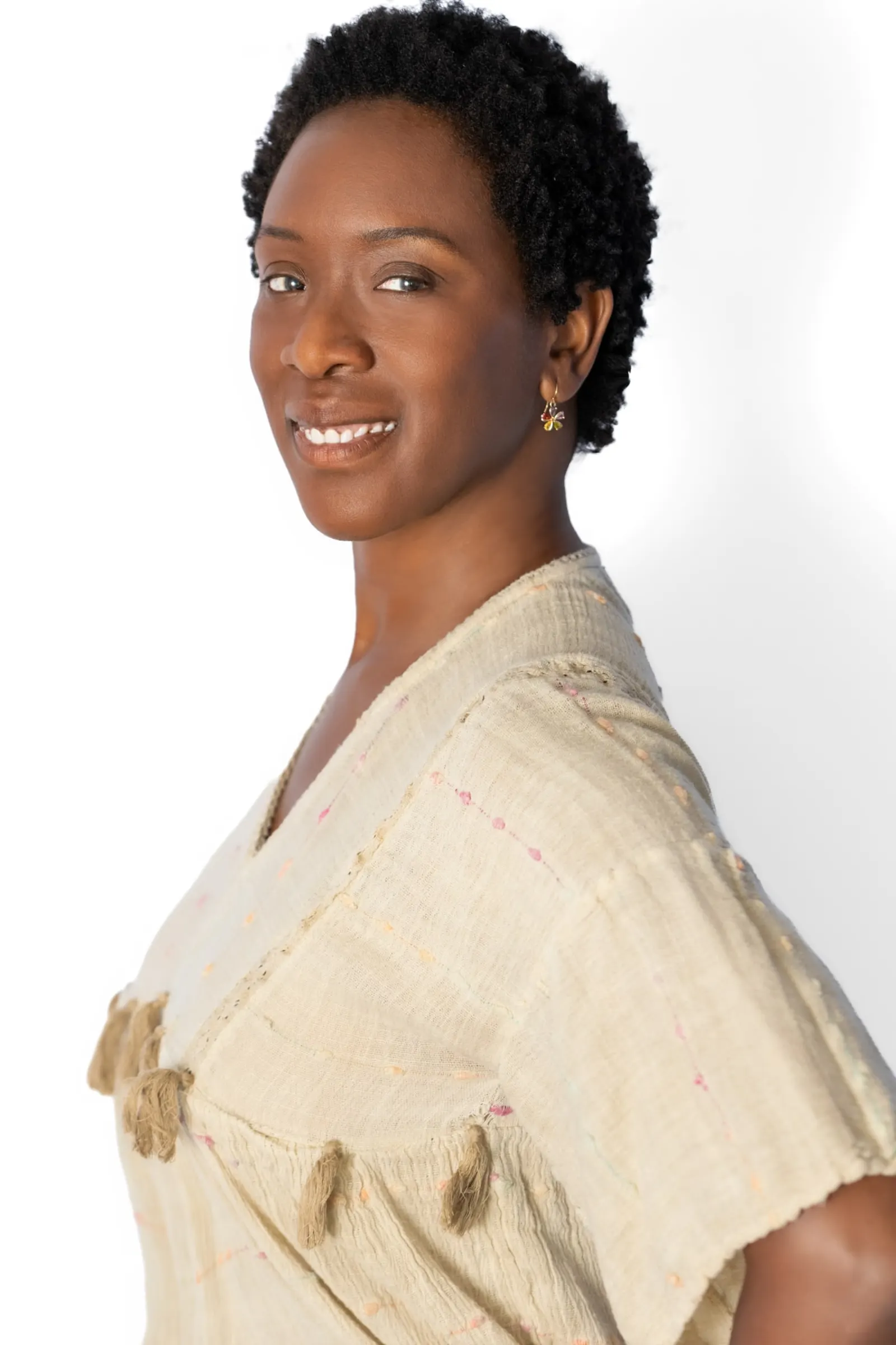 Yolessa Lawrinnce smiling, in a linen top