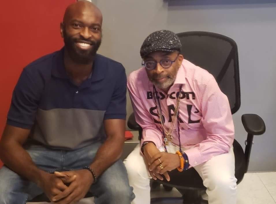 Michael Baptiste sitting with director Spike Lee