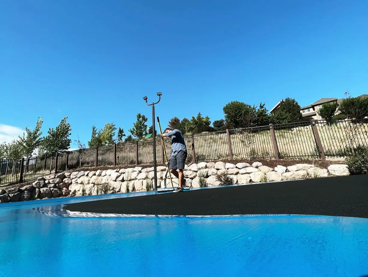 portrait of a man painting the surface for topic on Tennis and Pickleball Court Builder Companies