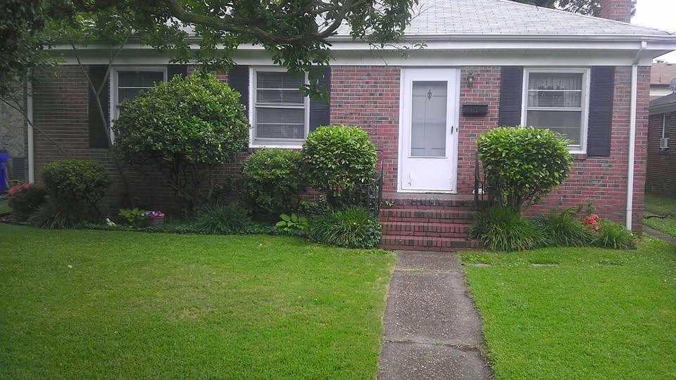 Small brick ranch house with a front lawn in Norfolk, Virginia