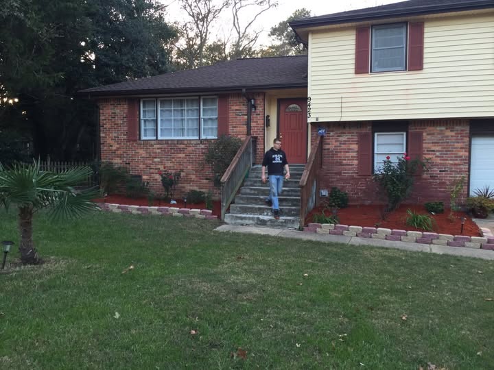 A two-story house with a front yard