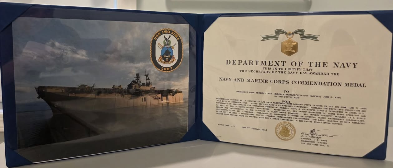 A Navy ship and John King's Navy and Marine Corps Commendation Medal certificate