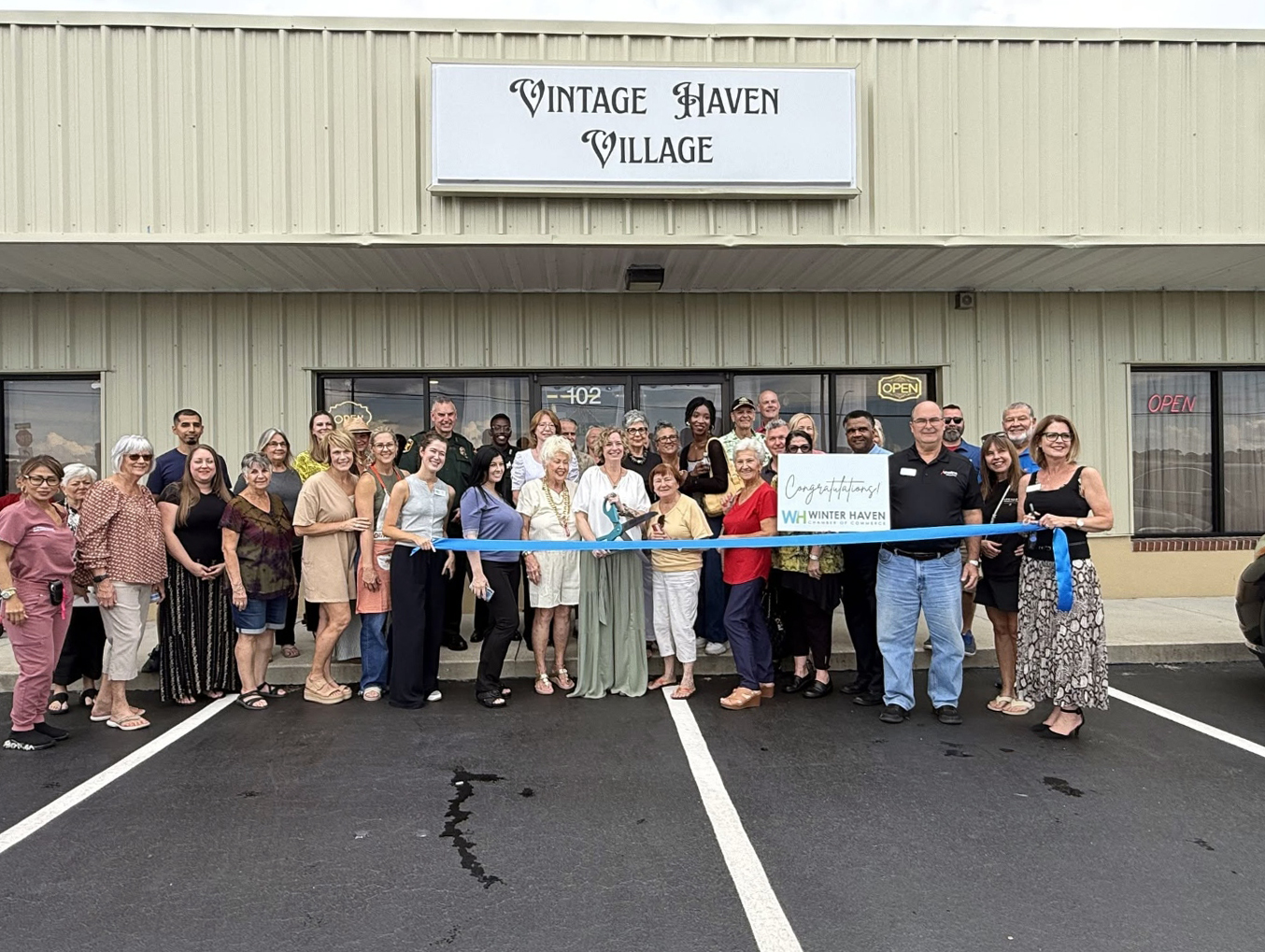 The ribbon-cutting gathering outside the Vintage Haven Village storefront