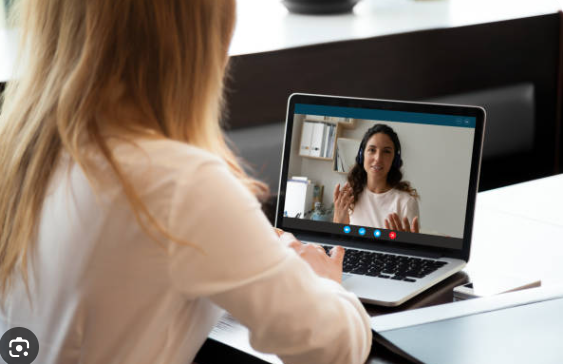 A woman on a live video coaching call with her recovery coach