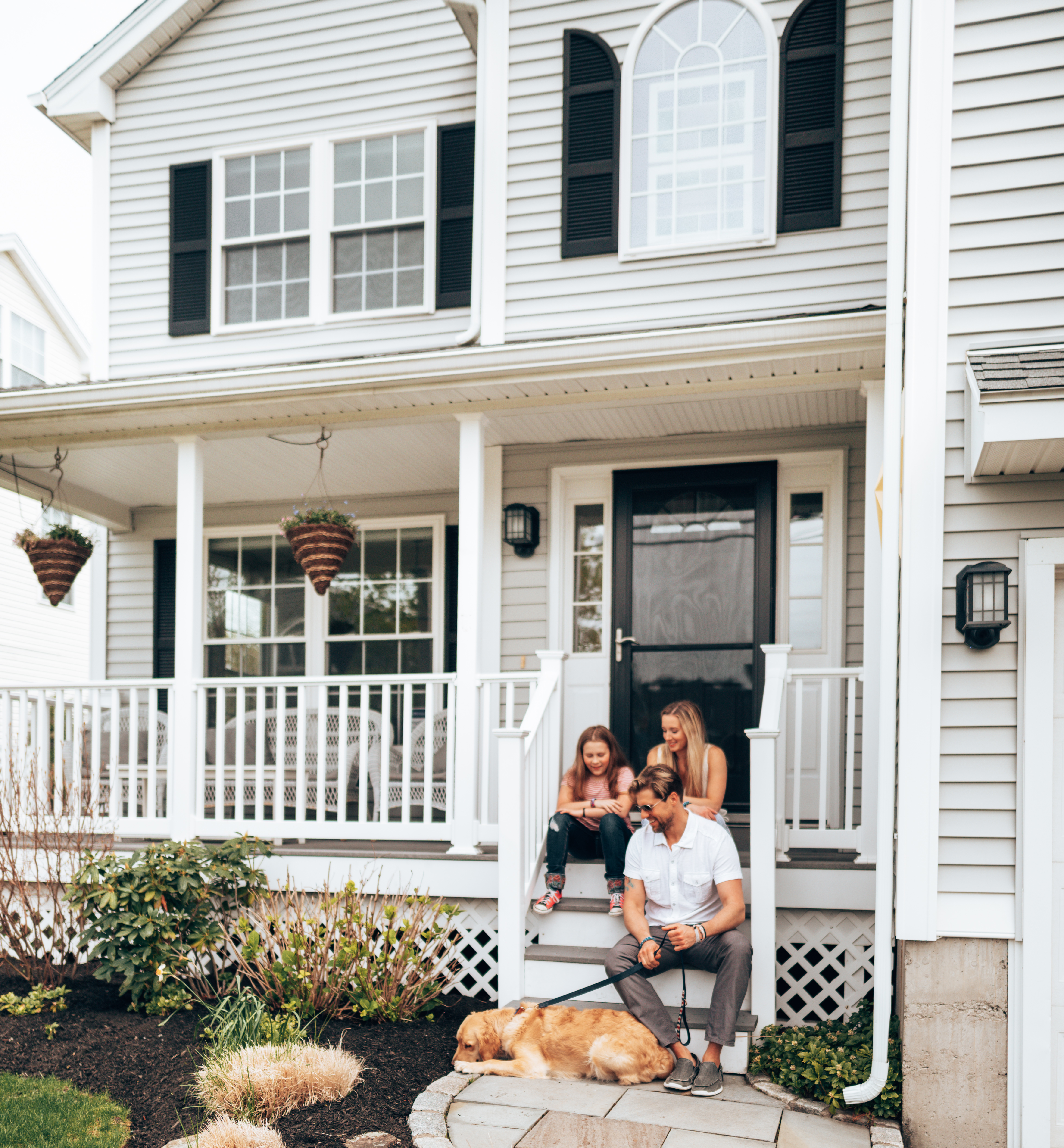 photograph of a happy family sat outside a pest free vancouver home