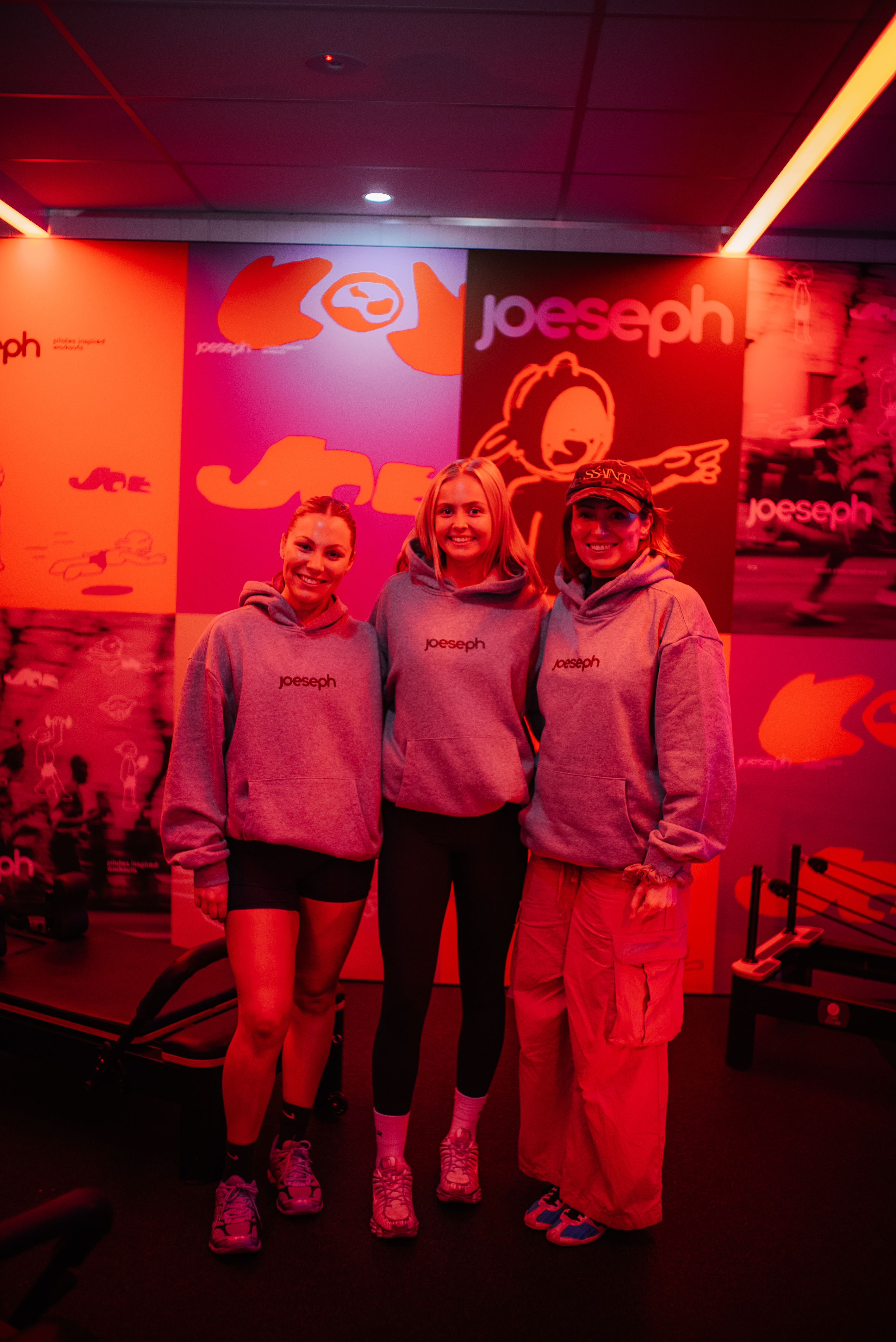 JOESEPH members together in branded hoodies