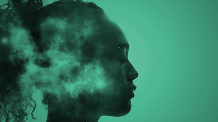 Side-profile silhouette of a woman’s head filled with drifting smoke and clouds against a teal background Side-profile silhouette of a woman’s head filled with drifting smoke and clouds against a teal background