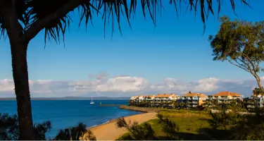 Coastline with palm trees and apartments